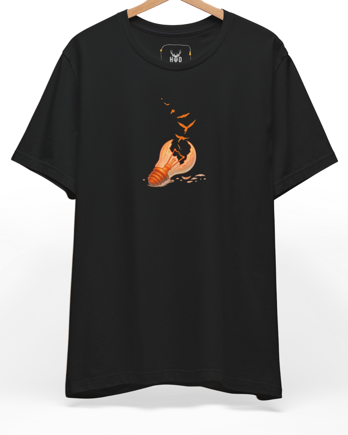 Premium Freedom Tshirt displaying a unique broken idea tee freedom concept light bulb birds graphic shirt layout on a black graphic tee backdrop, designed by Holydeer Clothing.
