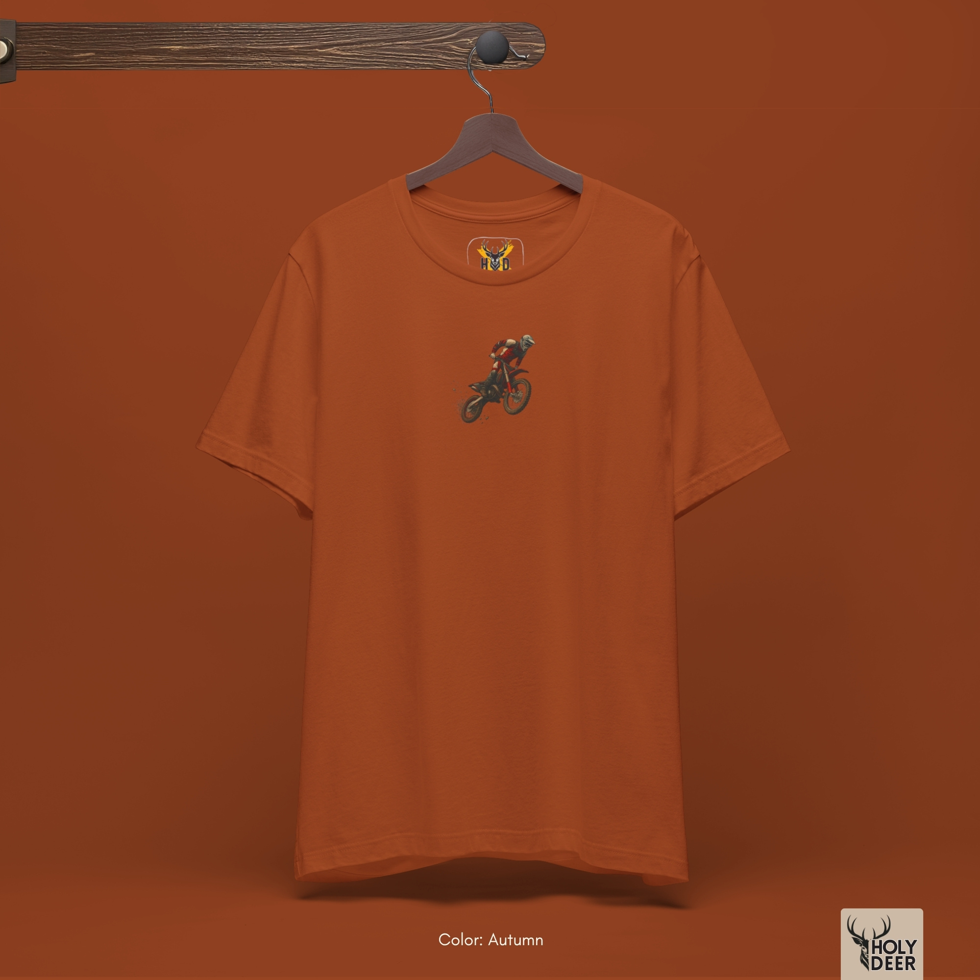 Soft amber desert ray shadow studio backdrop framing the unique Motocross Shirt by Holydeer Streetwear, magnifying the clean off-centered enduro graphic top placement and premium indie moto shirt presentation.
