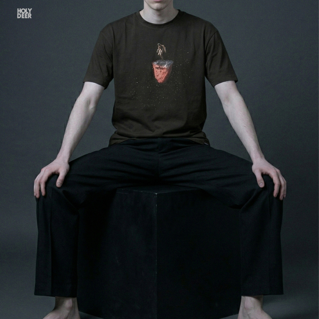 Industrial warehouse rave architecture outdoor lifestyle model wearing the centered Techno Rave Tshirt from Holydeer Clothing, standing as a high-end techno dj tshirt statement matching elite club dj shirt trends.