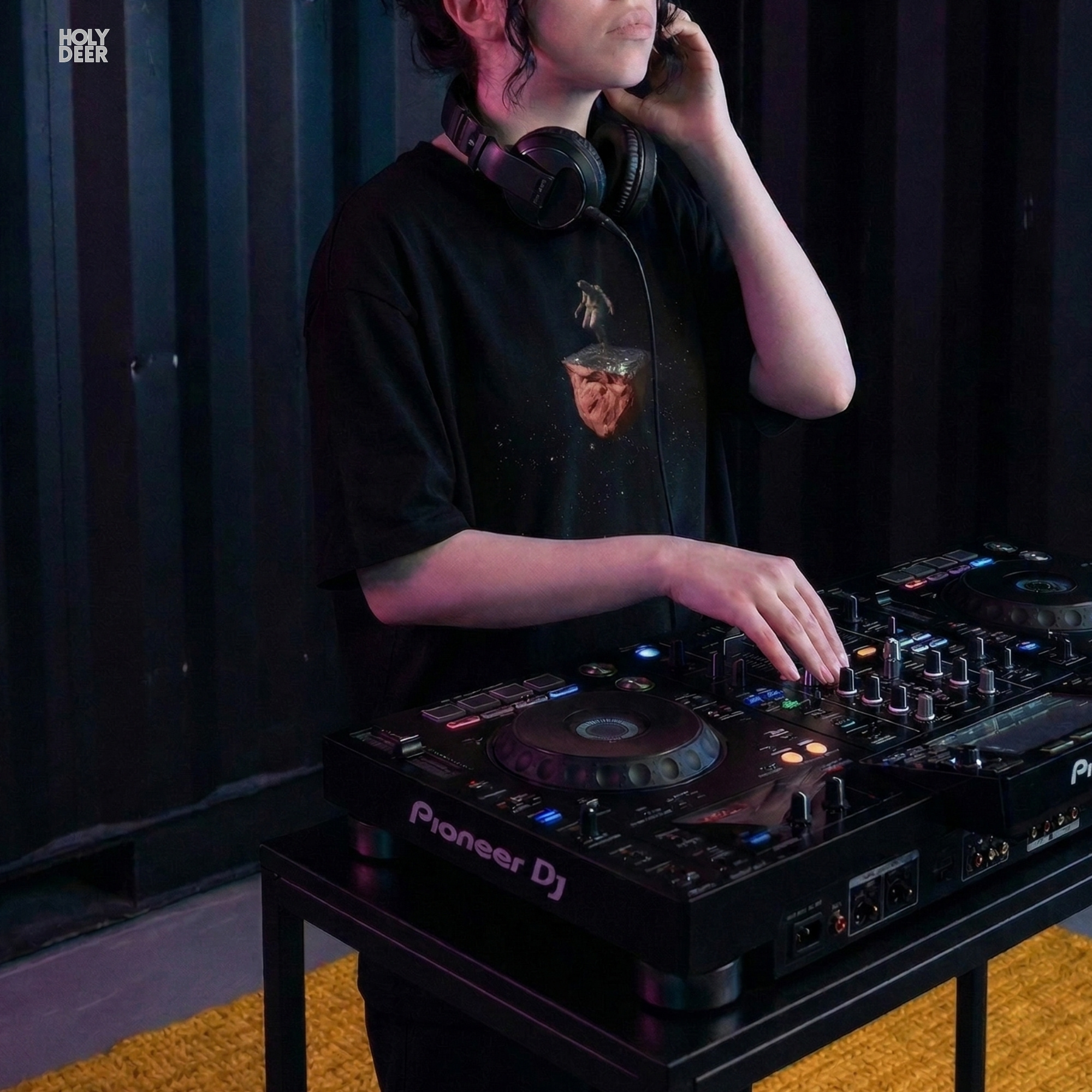 Professional flat lay photography of the Techno Rave Tshirt by Holydeer Apparel, arranged elegantly next to modular synth units and high-end deep space astronomy journals.