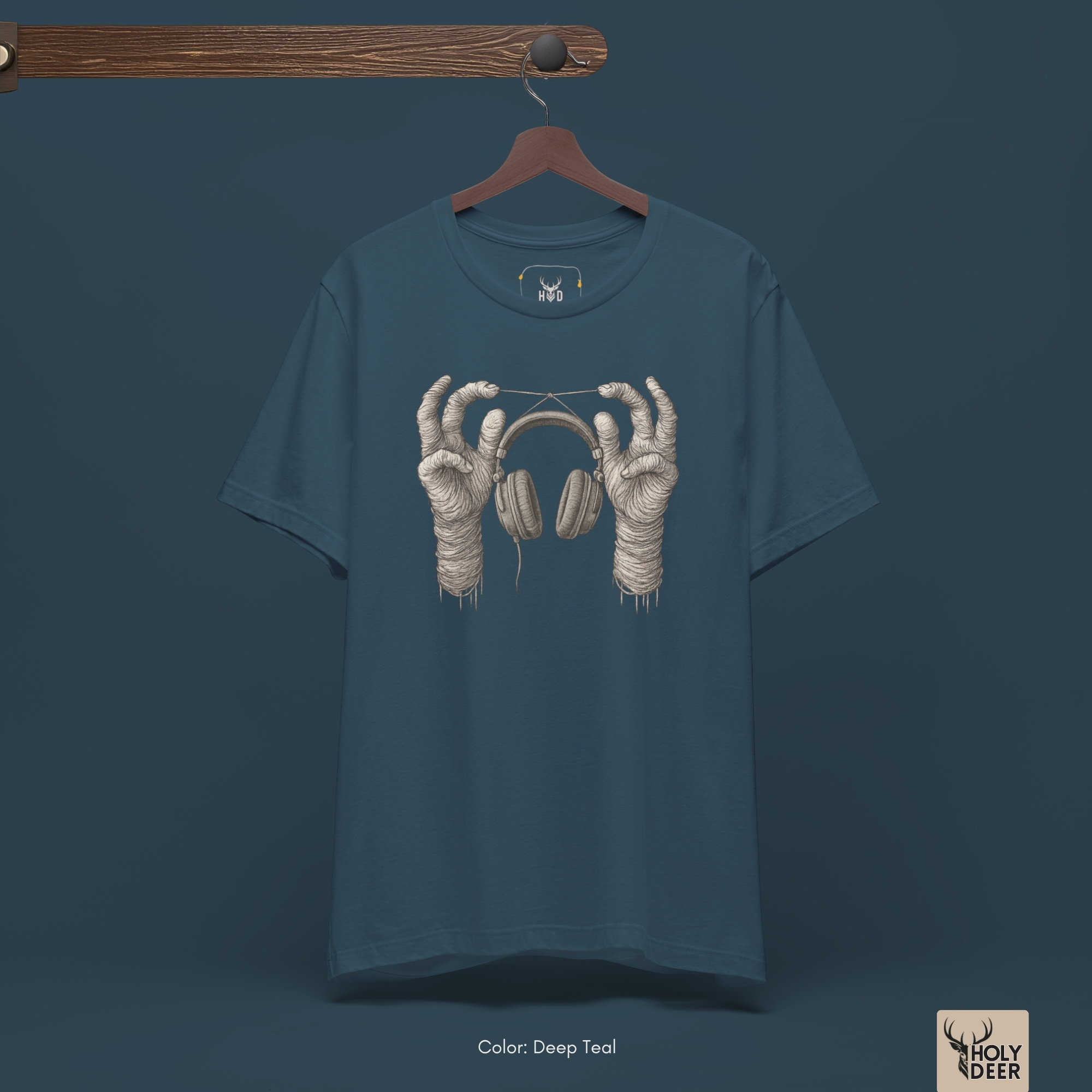 Professional flat lay photography of the Surreal Music Tee by Holydeer Apparel, arranged cleanly next to vintage analogue synthesizer modules, braided audio monitor cables, and gothic music style lifestyle essentials.
