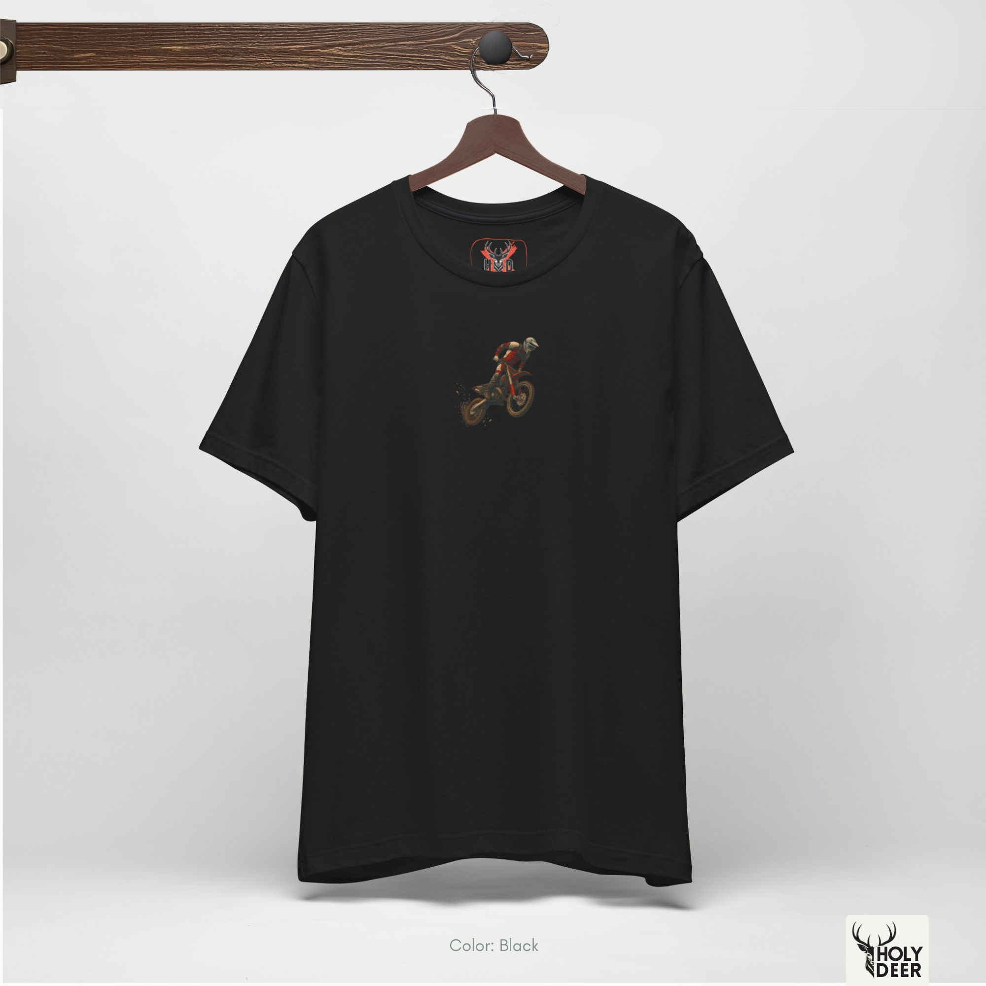 Angled perspective of the premium screen-printed Motocross Shirt, detailing the thick paint feel of the spinning rear tire silhouette and flying dirt lines, asymmetric chest placement, and the signature holydeer tee high-contrast design.