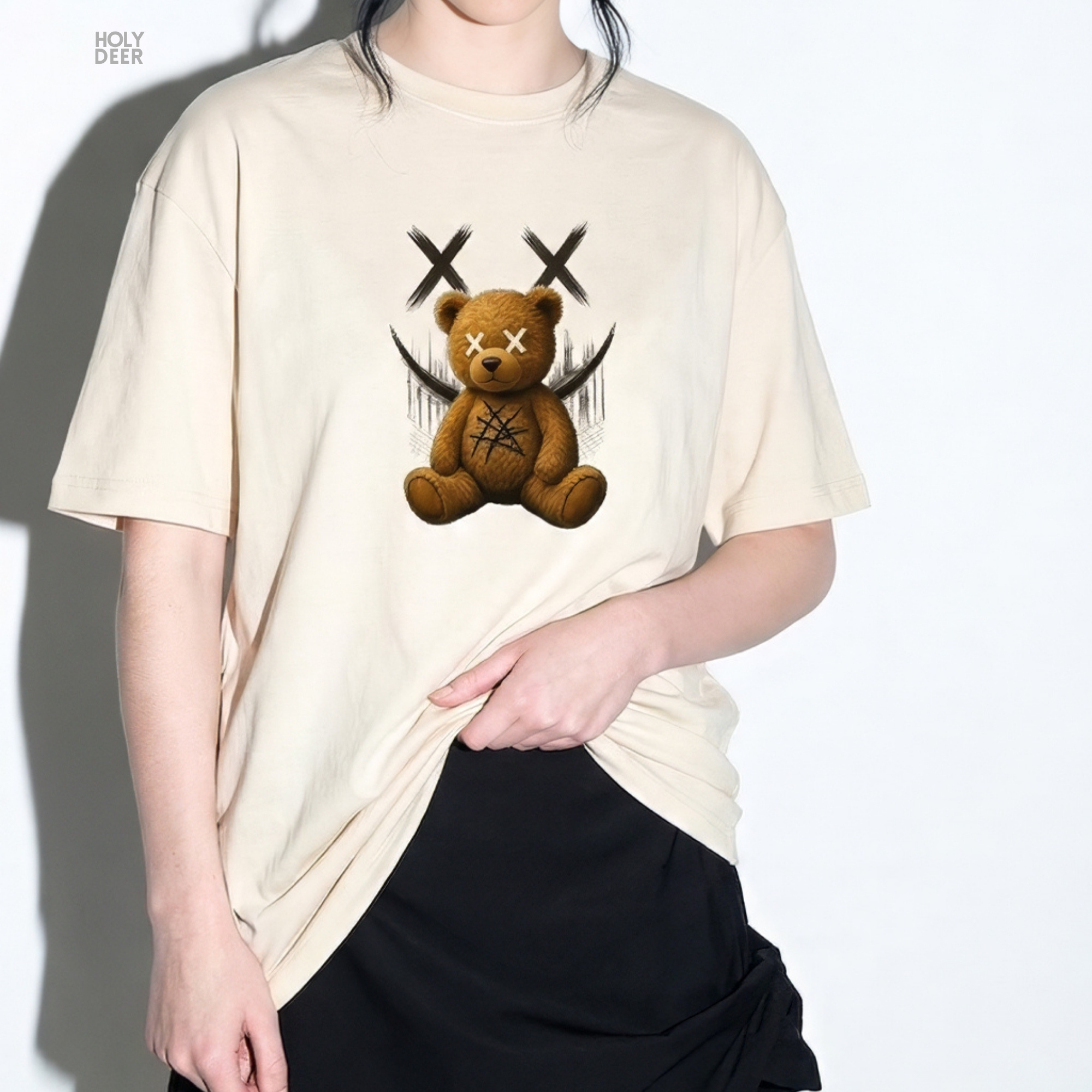 Overhead lookbook arrangement displaying the streetwear graphic tee folded neatly alongside textured metallic links, spray cans, and deep black shungite rock specimens.