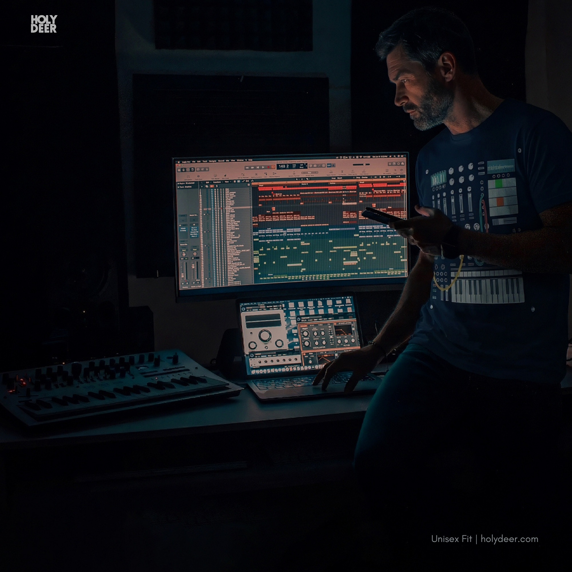 Angled perspective of the premium screen-printed Modular Synth Tee, detailing the thick paint feel of the green and orange step-sequencer pads and waveform analyzer displays, centered layout placement, and the signature holydeer tee high-contrast design.