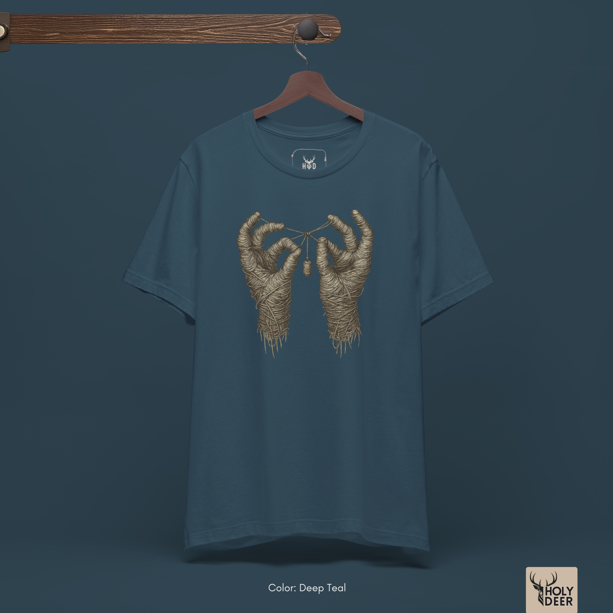 Minimalist dark backdrop focusing heavily on the standalone frame of the Mummy Hands Shirt by Holydeer, proving it acts as a unique wearable art piece and an essential mummy wrap graphic collectible.