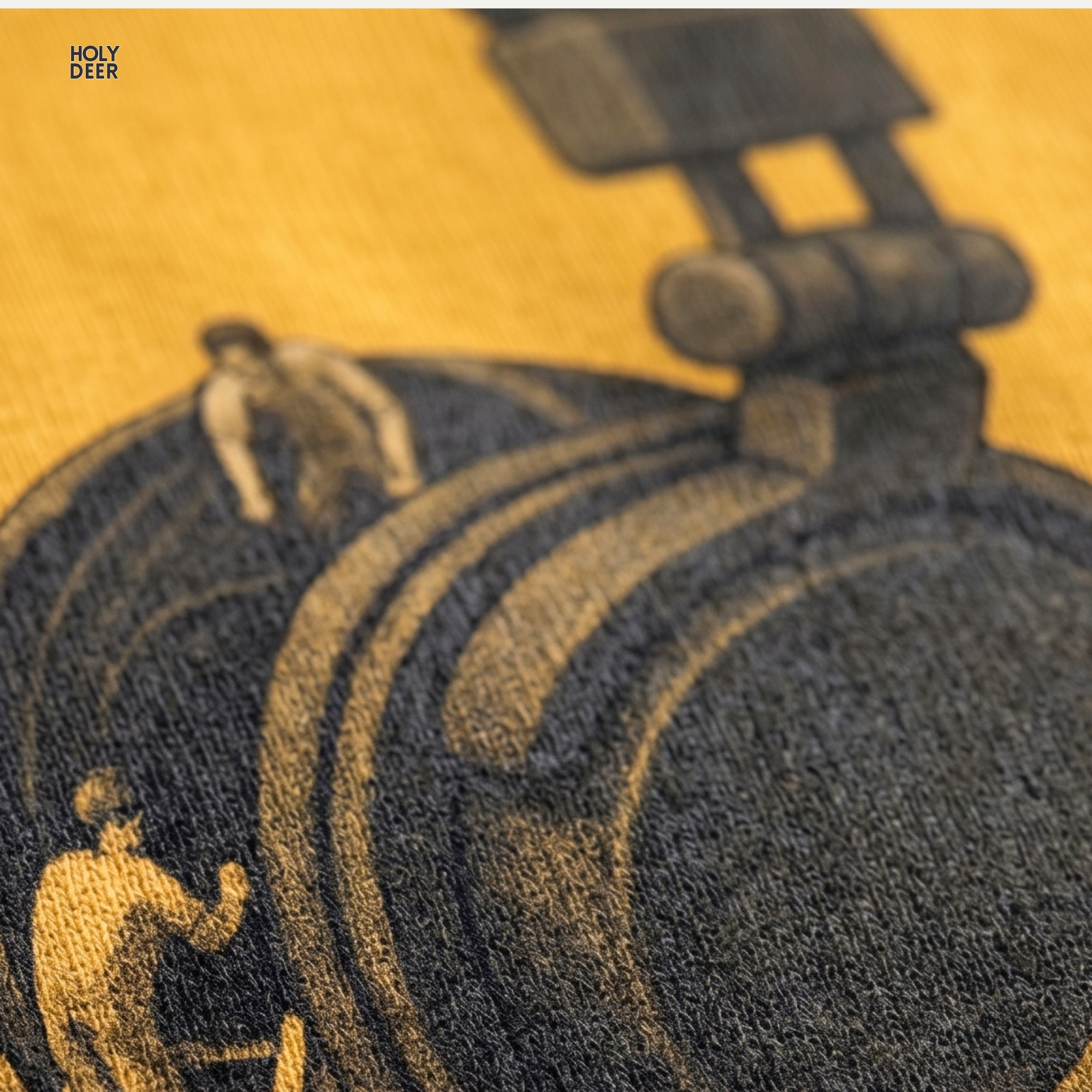 High-magnification print detail tracking a small shaded human figure climbing a tiny ladder inside the ear cup cavity of the music engineer tee.