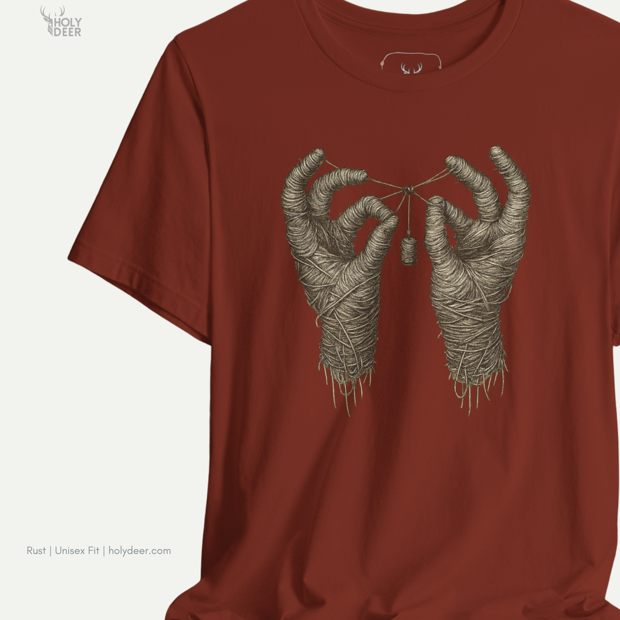 Macro view of the fine line-art details and clean contrast shading on the single hanging thread fragments and meticulous fabric weave simulation embedded in the Mummy Hands Shirt artwork, showing the print depth that separates this holydeer tee from generic products.