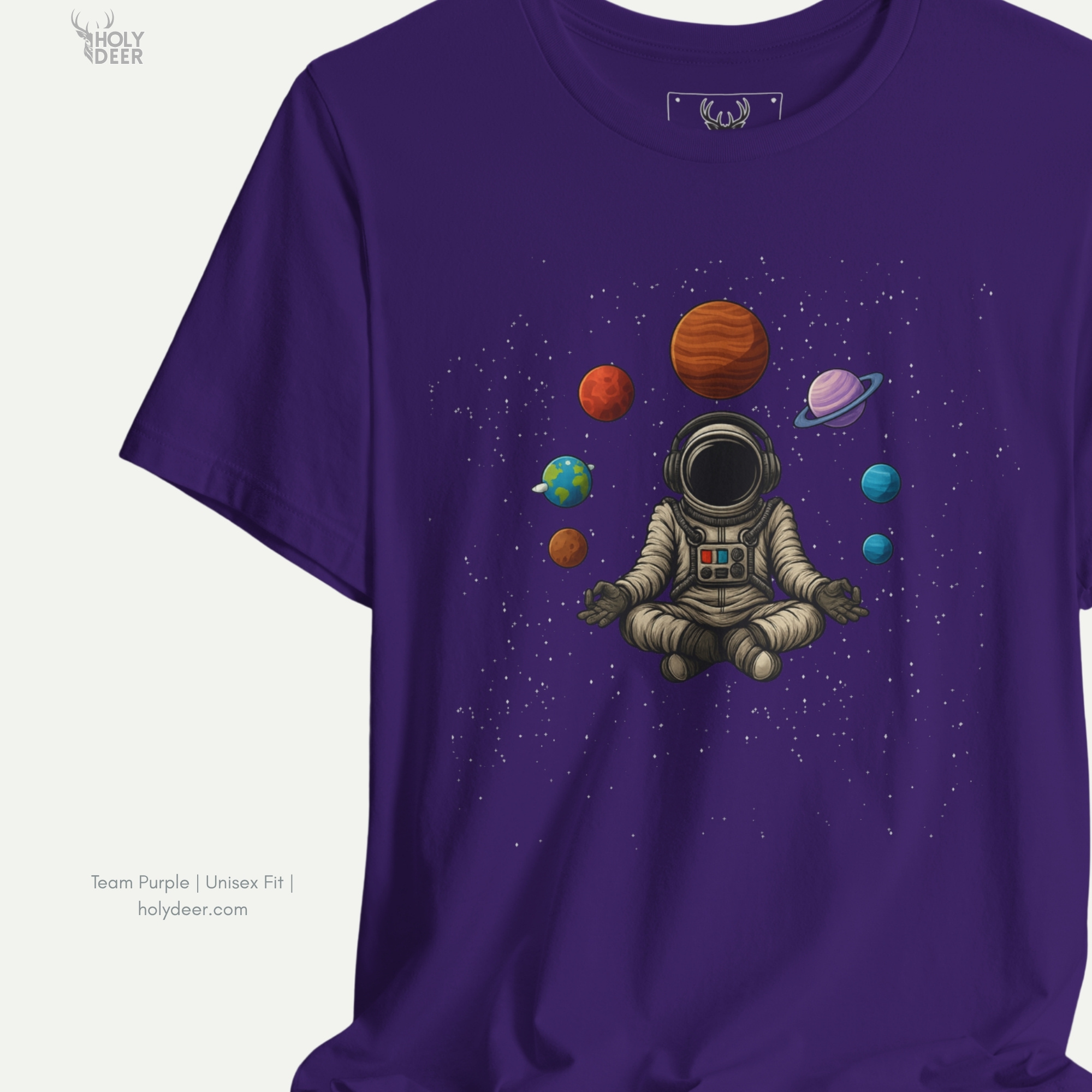 Angled perspective of the premium screen-printed Astronaut Meditate, detailing the thick paint feel of the folded suit legs and heavy spacesuit sole details, center layout placement, and the signature holydeer tee high-contrast design.