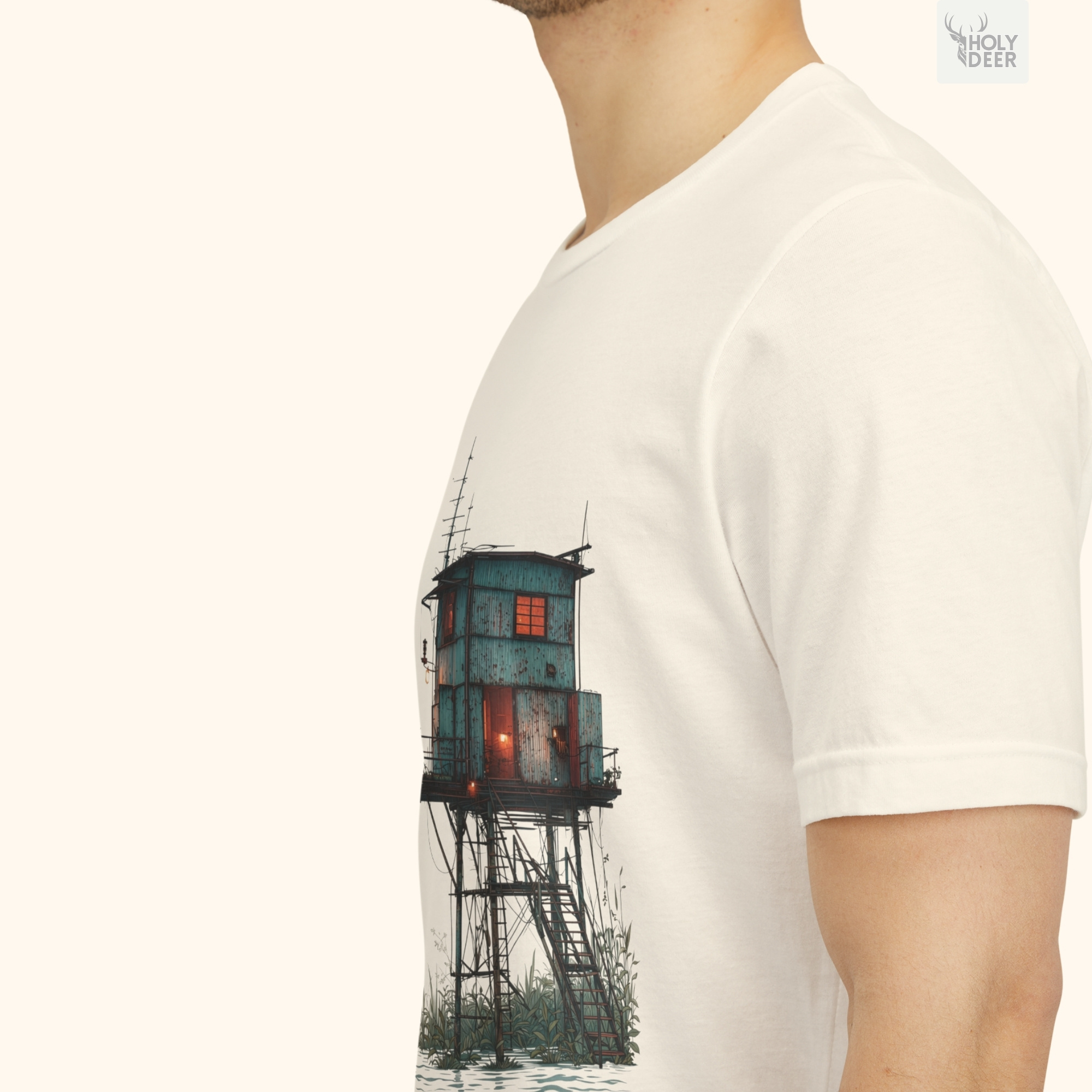 Soft twilight shadow studio backdrop framing the unique Surreal Coastal Watchtower Shirt by Holydeer Streetwear, magnifying the clean centered ocean house tee placement and premium unique graphic tee presentation.