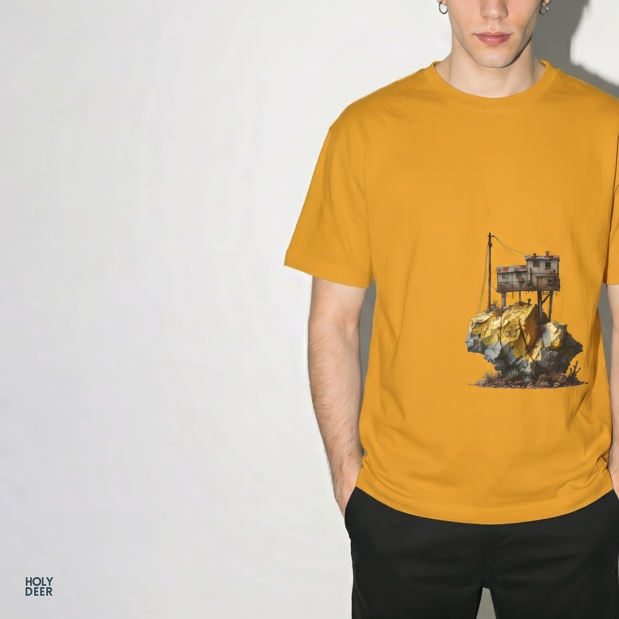 Technical close-up highlighting the stippled geological fractures, rich ochre stone shading, and miniature succulent vegetation anchoring the base of the tiny house shirt art.