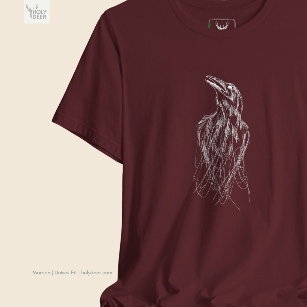 High-magnification print detail capturing the dense white hatch marks framing the calling beak, sharp skull crown boundaries, and textured ink overlaps of the gothic crow tee.