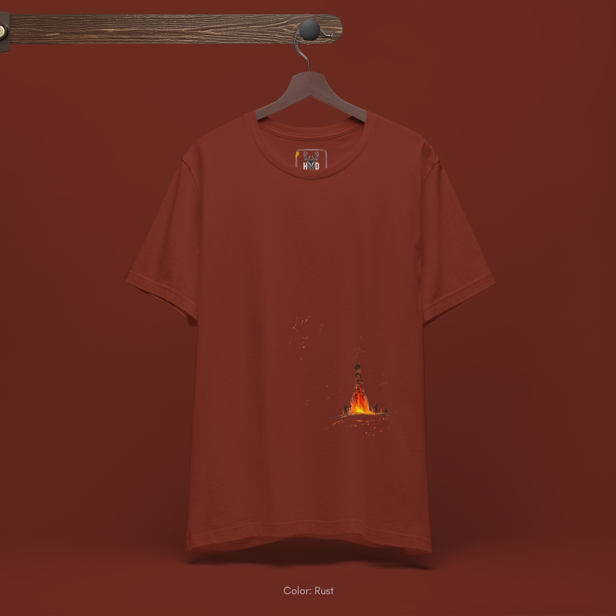Candid tracking shot capturing an individual walking through a shadowed twilight forest clearing while wearing the bonfire gift top.