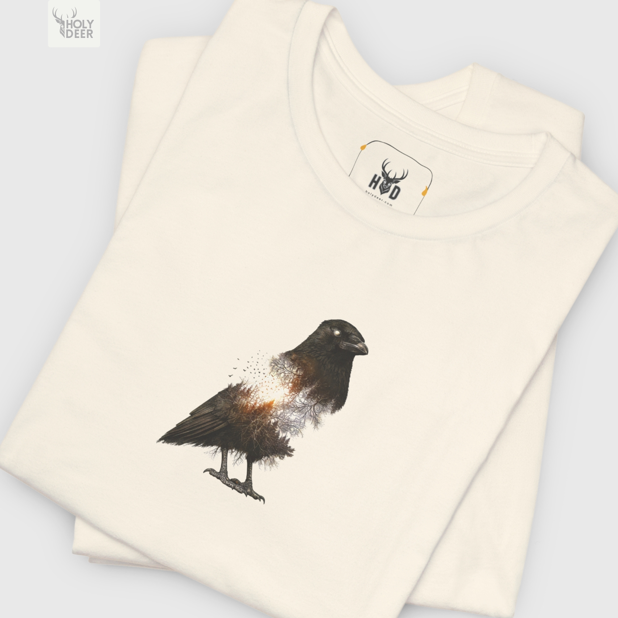 Technical close-up highlighting the sprawling needle branches, tiny flying bird silhouettes breaking off the spine, and deep black shading anchoring the core of the raven art tee.