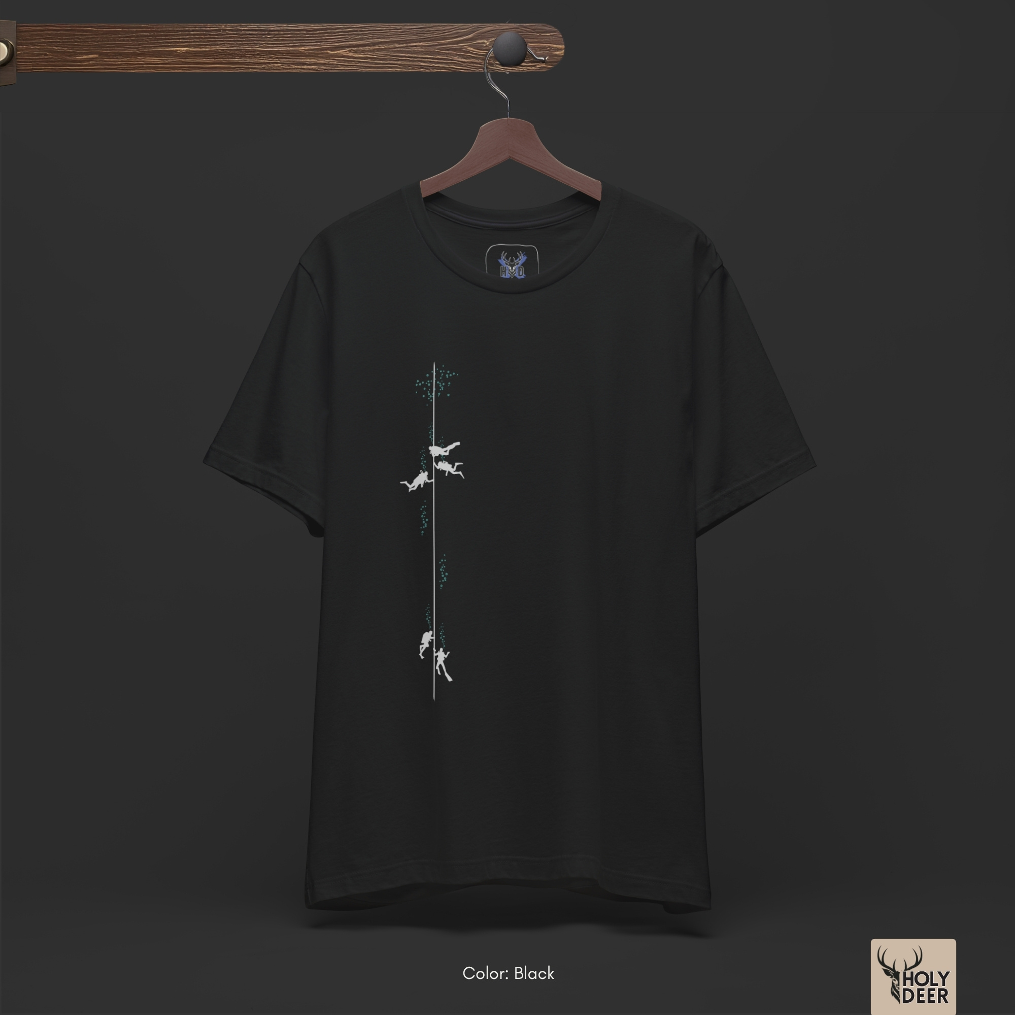 Dark shadow studio backdrop framing the unique Scuba Diving Tee by Holydeer Streetwear, magnifying the clean off-centered diver graphic top placement and premium scuba life art presentation.