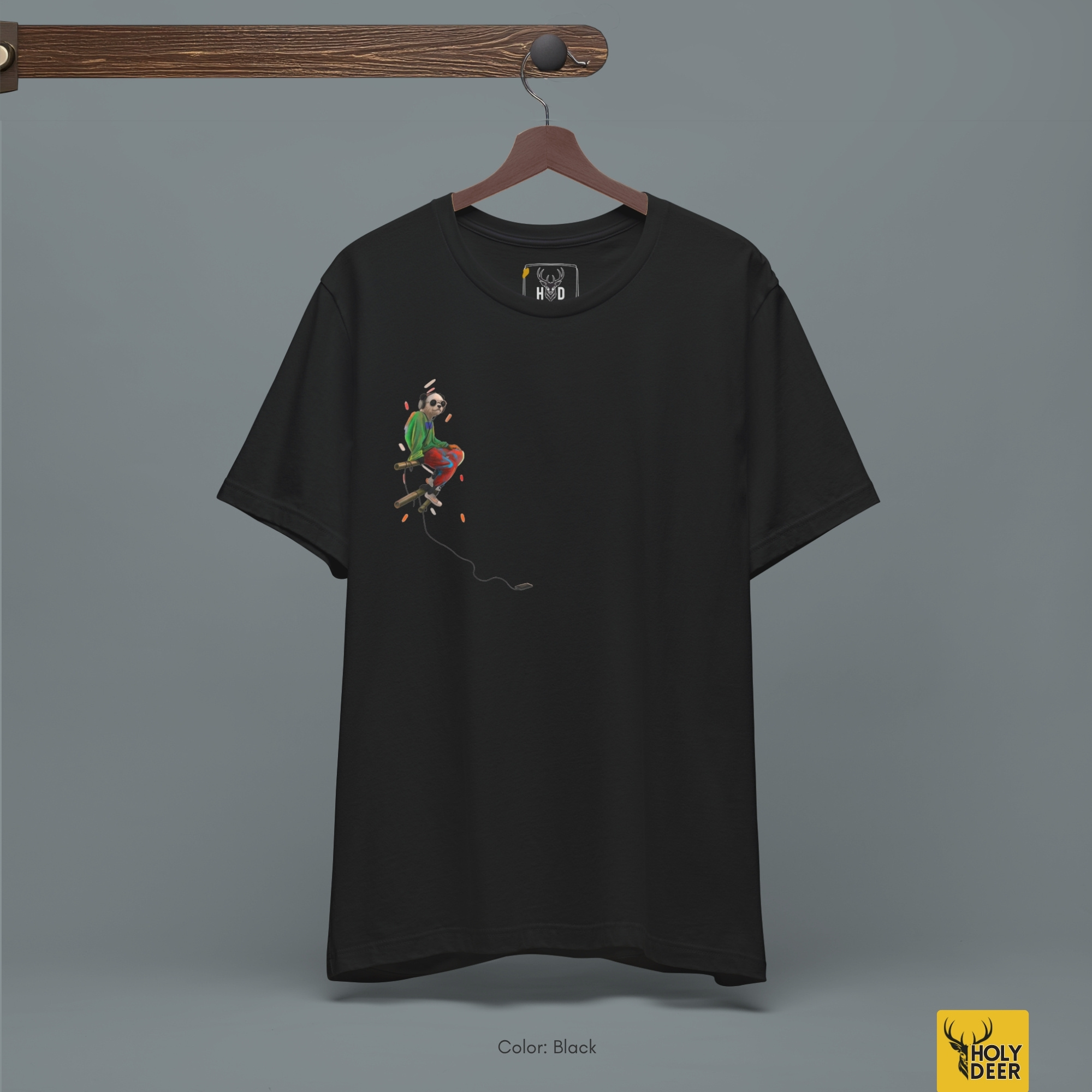 Angled perspective of the premium screen-printed Music Panda Tee, detailing the thick paint feel of the bright green jacket and flying pastel particles, chest layout placement, and the signature holydeer tee high-contrast design.