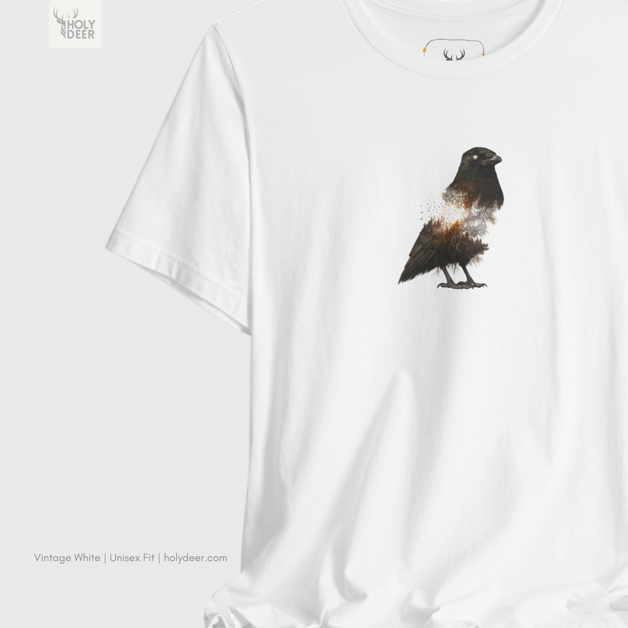 A macro perspective tracking the sharp black beak outlines and the high-contrast blank white eye defining the skull structure of the crow graphic tee.