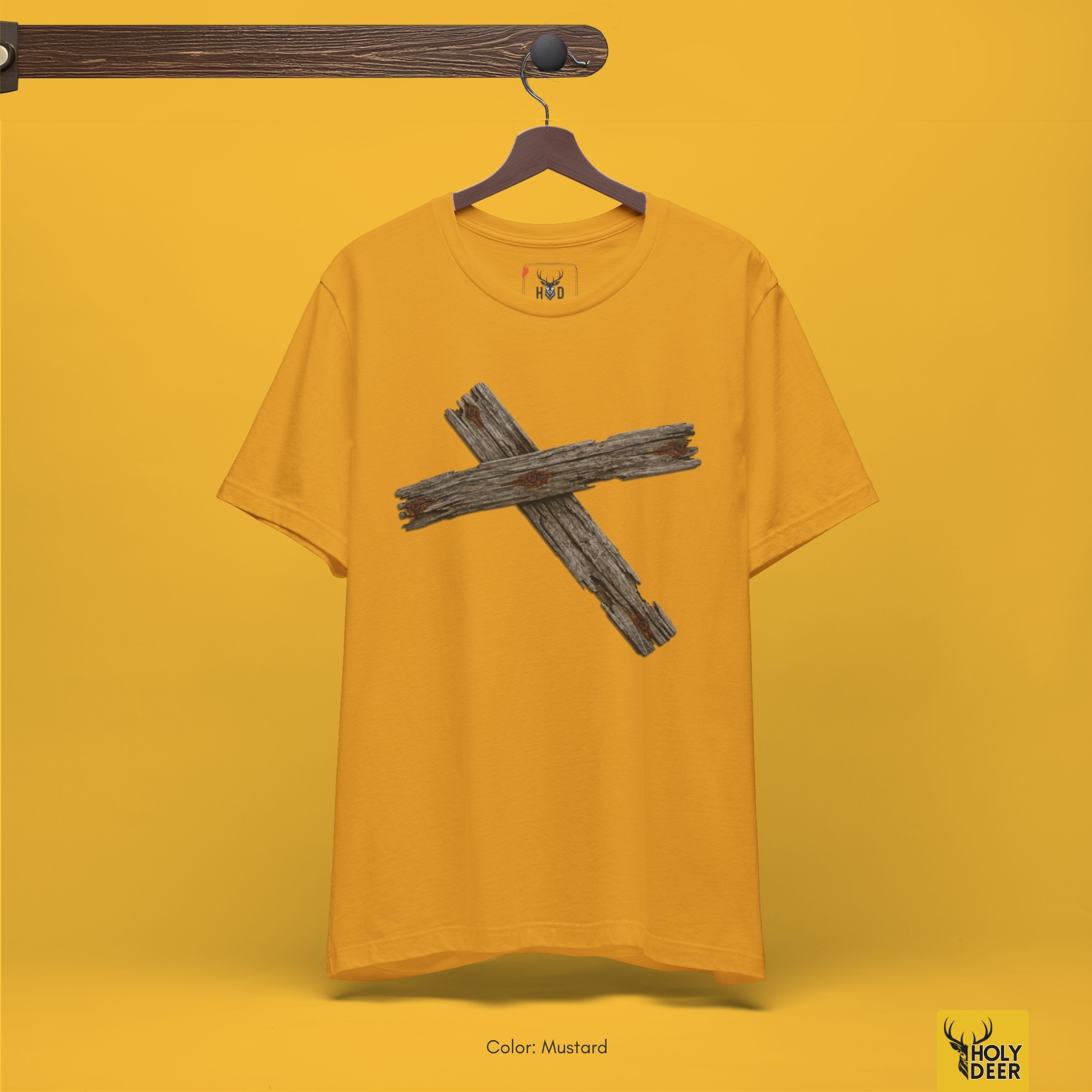 Professional flat lay photography of the Wooden Cross Tshirt by Holydeer Apparel, arranged cleanly next to genuine weathered barn wood fragments, crude blacksmith forged iron spikes, and rustic cross tee lifestyle essentials.