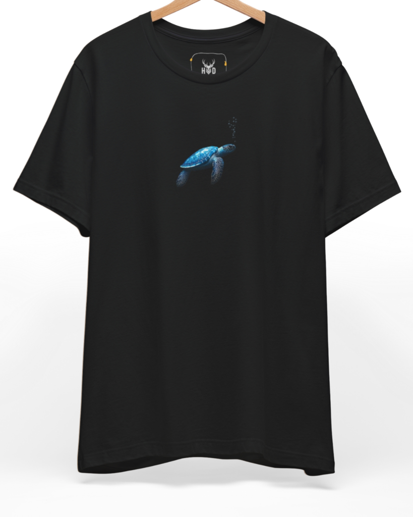 An eye-level studio presentation highlighting the calm-ocean-tee-blue-turtle-minimal-design-underwater-visual-story-holydeer-inspired.jpg artwork centered on a premium combed deep teal cotton canvas by Holydeer Clothing.
