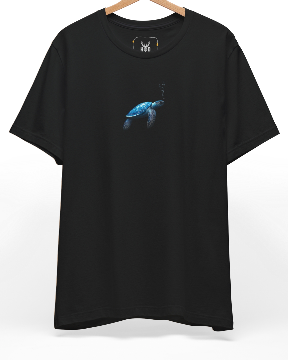 An eye-level studio presentation highlighting the calm-ocean-tee-blue-turtle-minimal-design-underwater-visual-story-holydeer-inspired.jpg artwork centered on a premium combed deep teal cotton canvas by Holydeer Clothing.