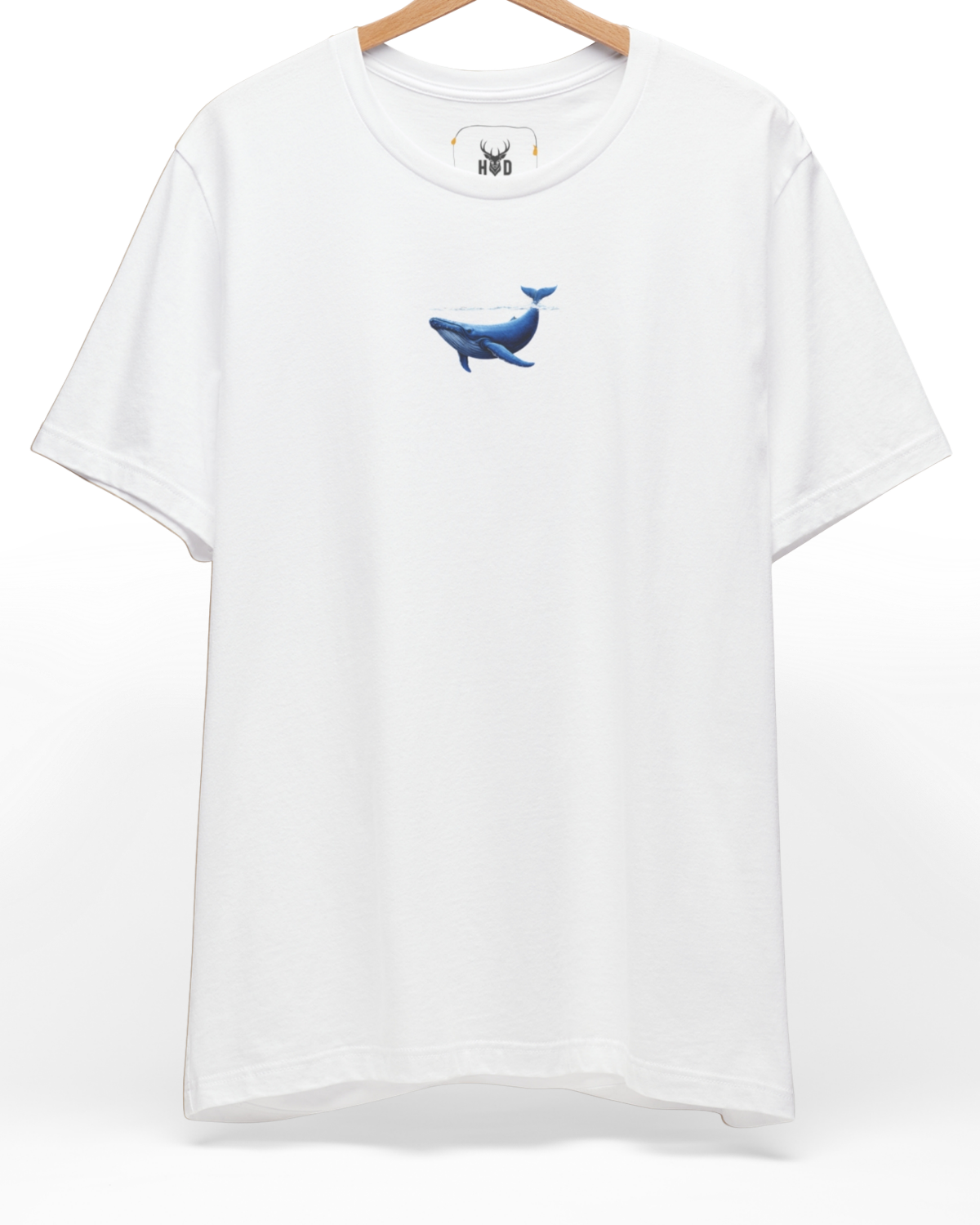 An eye-level studio presentation highlighting the calm-ocean-tee-blue-whale-surface-minimal-design-underwater-visual-holydeer-style.jpg artwork aligned on the upper left chest of a premium combed black cotton canvas by Holydeer Clothing.