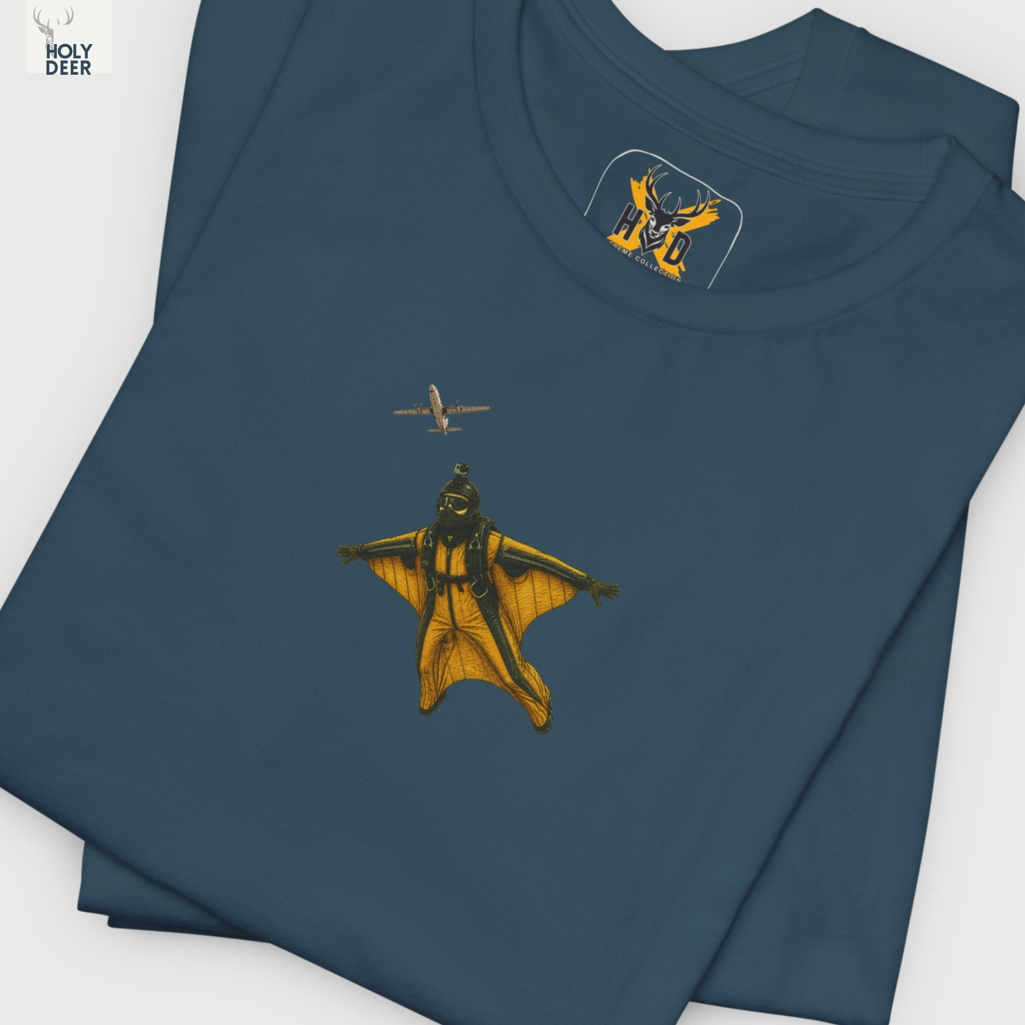 Professional flat lay photography of the Wingsuit Pilot Tee by Holydeer Apparel, arranged elegantly next to premium unique athlete gift layouts and high-end wingsuit flying blueprints.