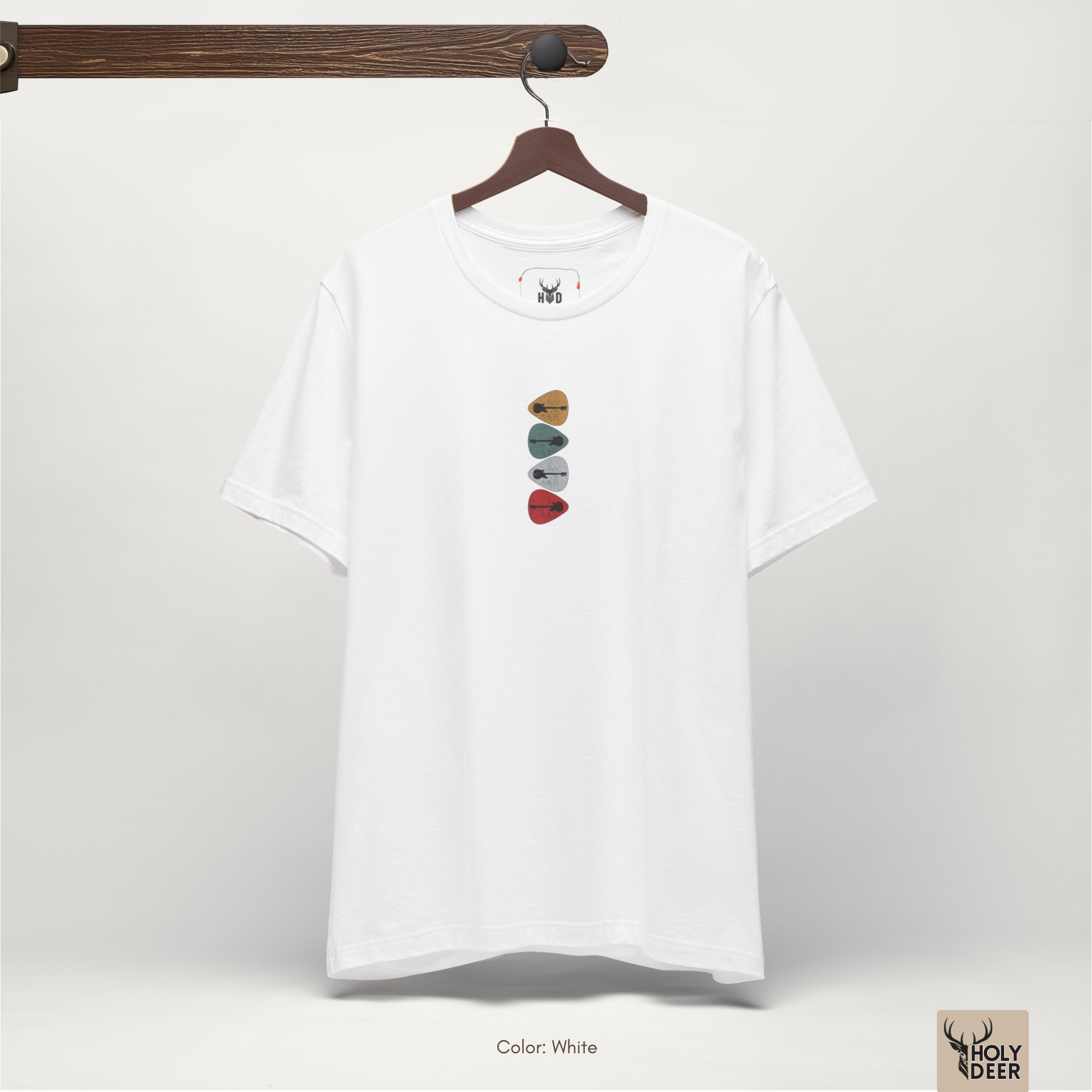 Soft shadow studio backdrop framing the unique Retro Guitar Shirt by Holydeer Streetwear, magnifying the clean centered guitar pick tee placement and premium unique artist gift presentation.