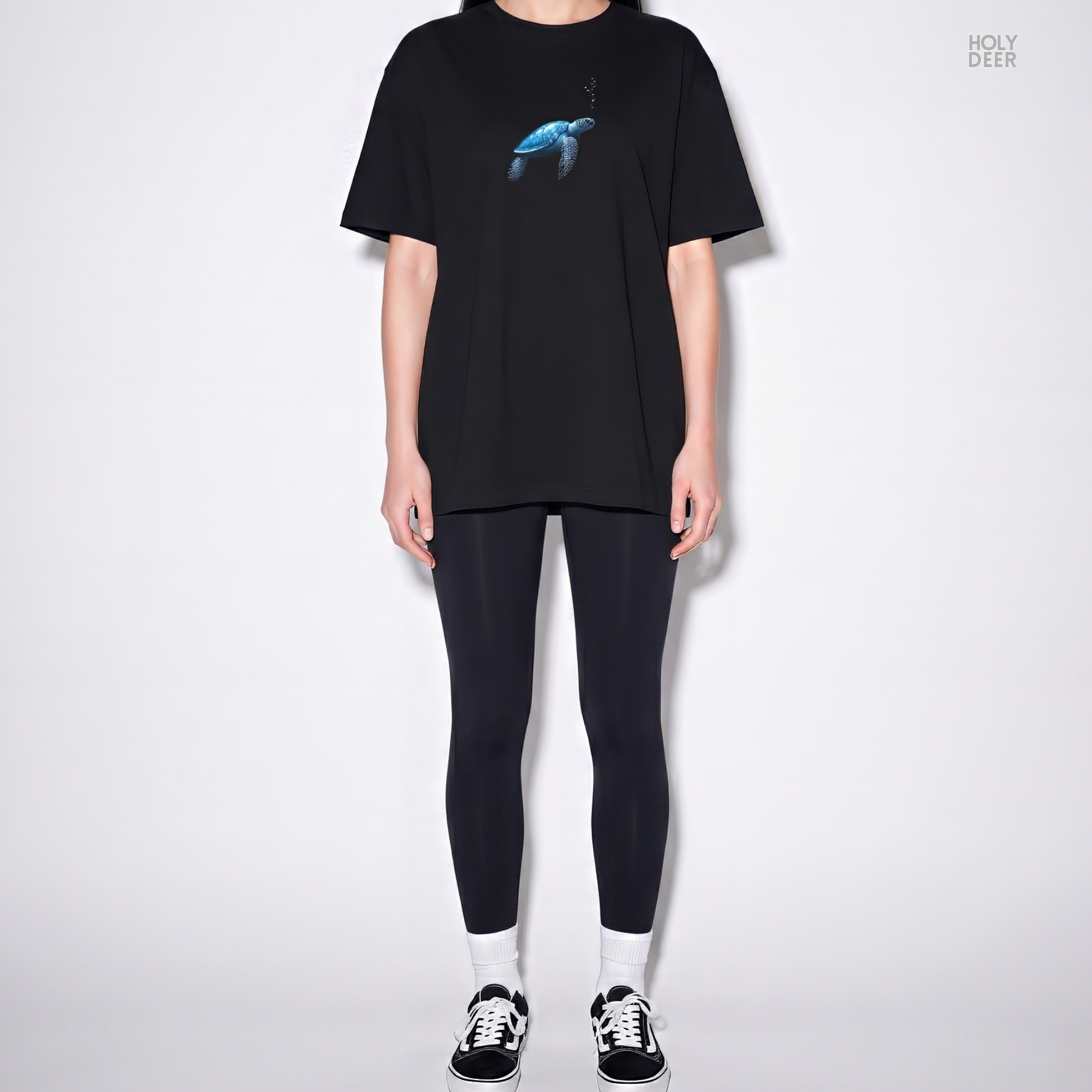 An eye-level studio presentation highlighting the calm-ocean-tee-blue-turtle-minimal-design-underwater-visual-story-holydeer-inspired.jpg artwork centered on a premium combed deep teal cotton canvas by Holydeer Clothing.