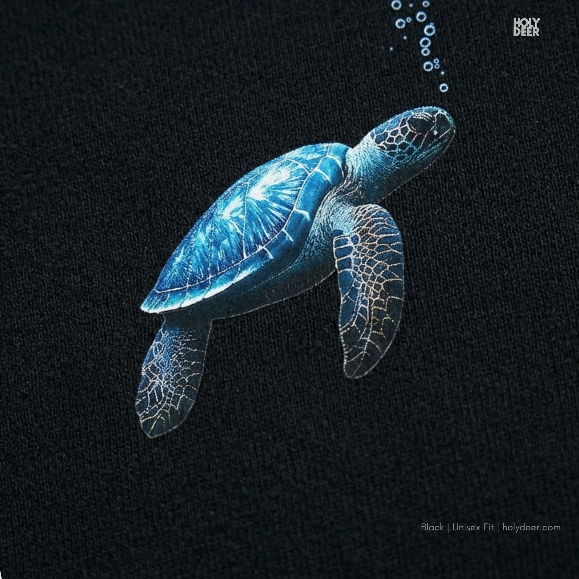 High-magnification print detail capturing the textured cerulean blue shell, intricate flipper scale patterns, and rich indigo gradient saturation of the blue turtle tee.