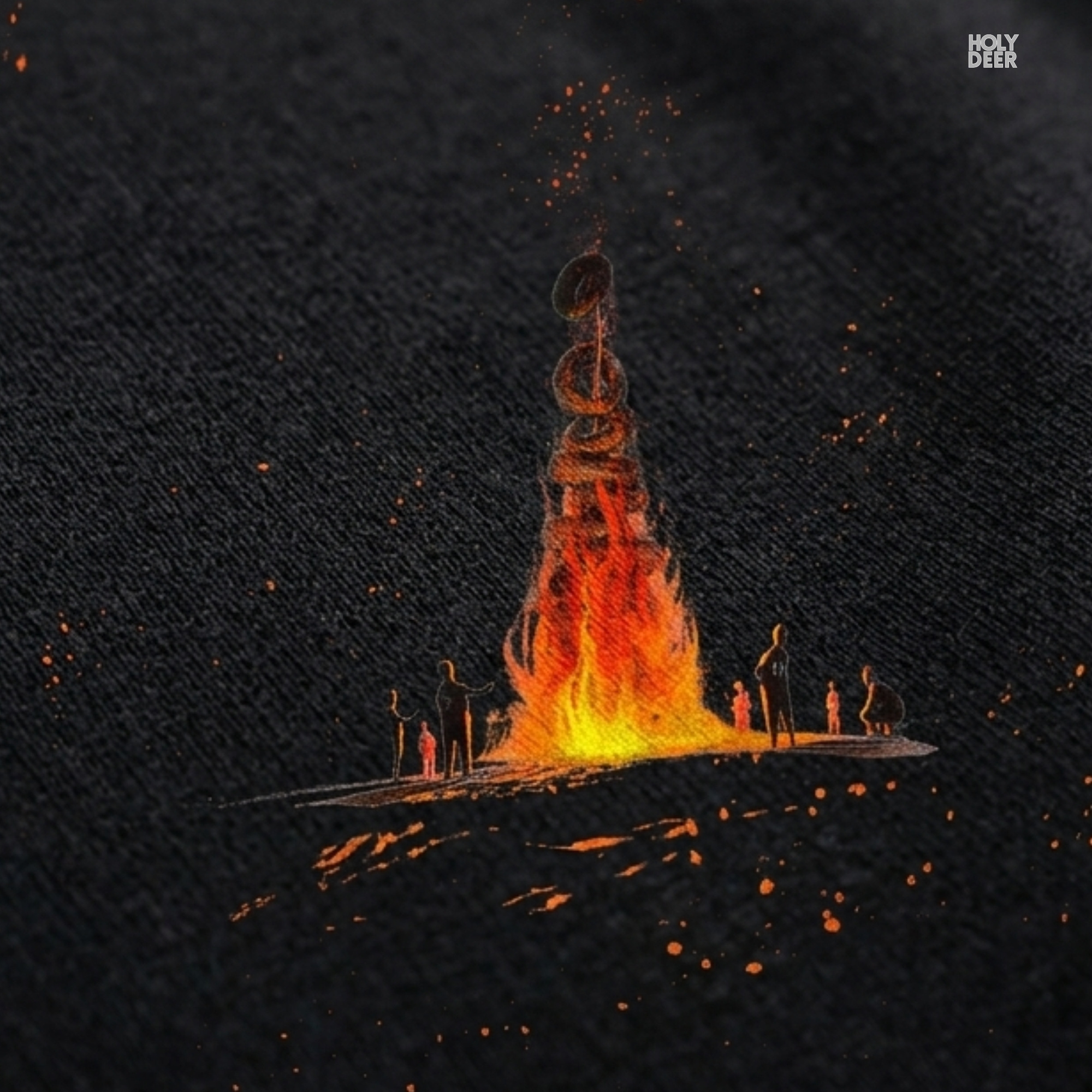 High-magnification print detail tracking the intense yellow heat center, deep orange flame contours, and dark log shadows forming the core of the fire graphic tee.