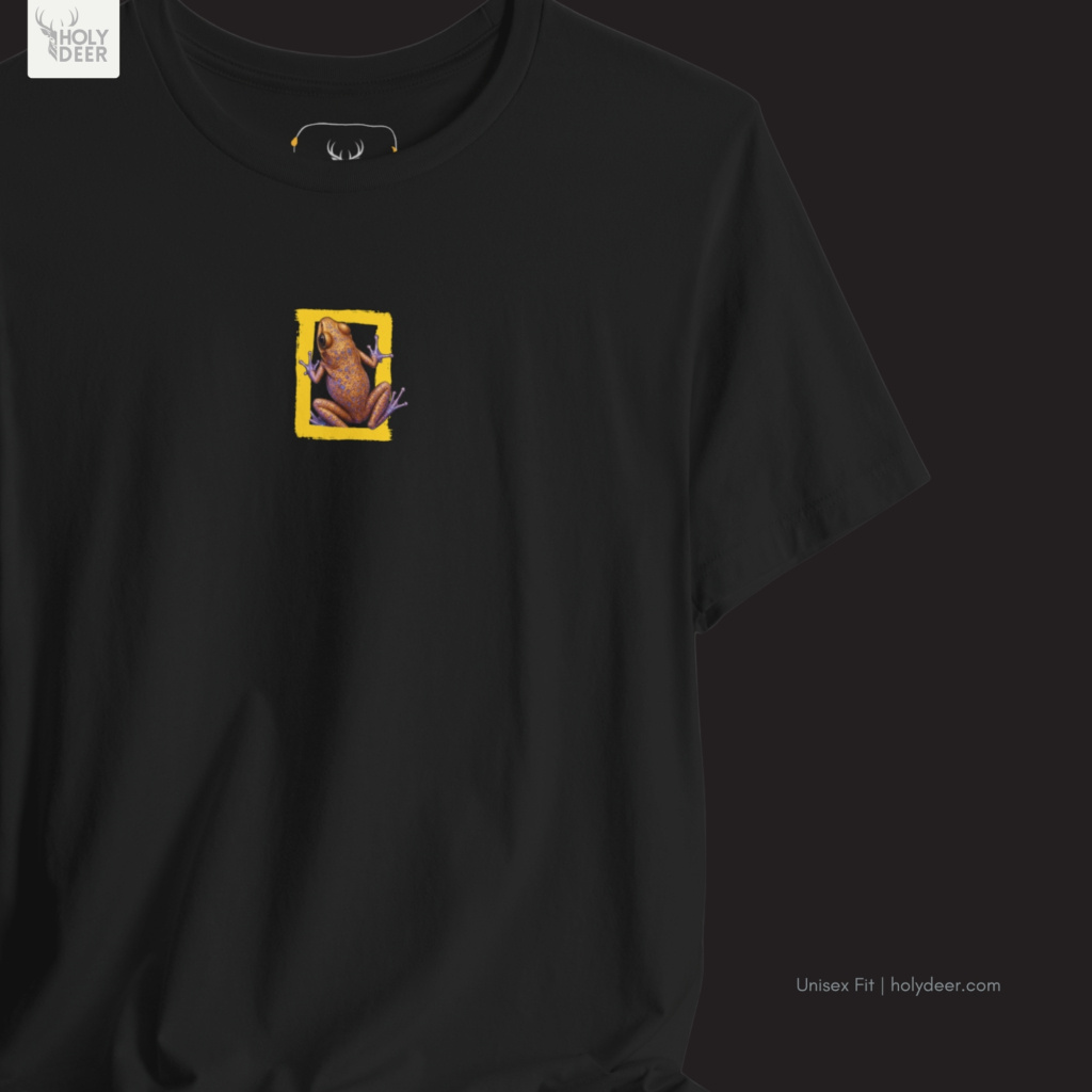 A top-down lifestyle layout featuring the unique artist gift tee neatly folded next to real raw orange-red minerals and classic wilderness expedition tools.