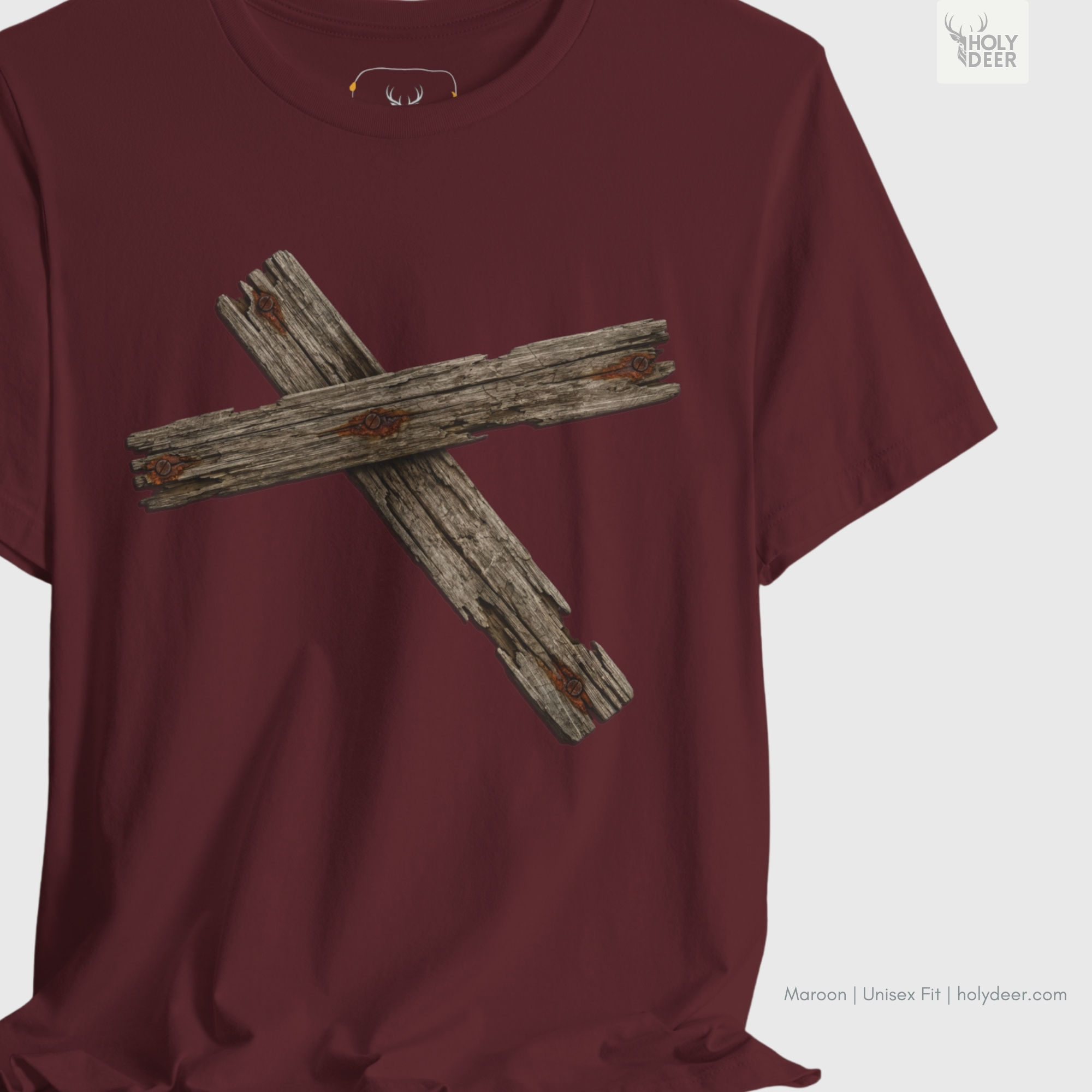 The iconic Wooden Cross Tshirt hanging cleanly on a luxury wood hanger, highlighting the robust neckline structure, crisp centered organic timber layout flow, and the official holydeer.com retail tags.