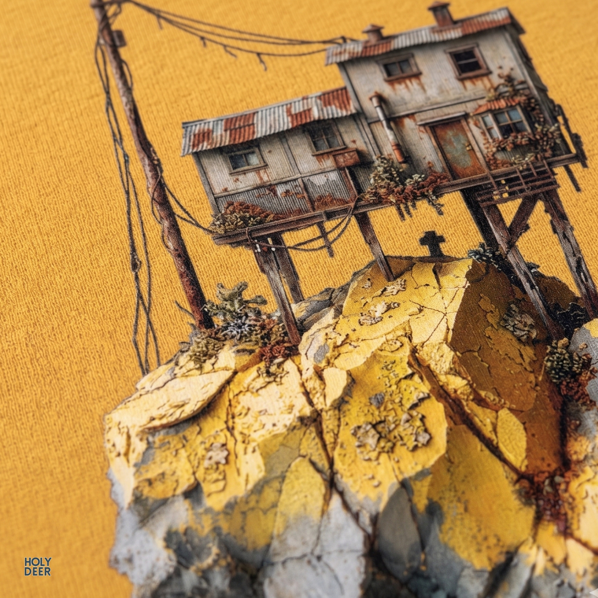High-magnification print detail capturing the splintered structural stilts, corrugated rusted roofing sheets, and delicate window wireframes of the surreal house tee.