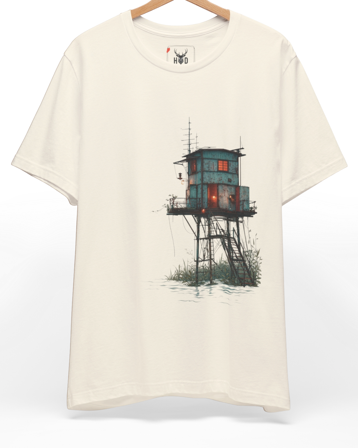 Premium Surreal Coastal Watchtower Shirt displaying a high-detail blue industrial tower and warm orange window light concept on a soft color tee cream layout, designed by Holydeer Clothing.