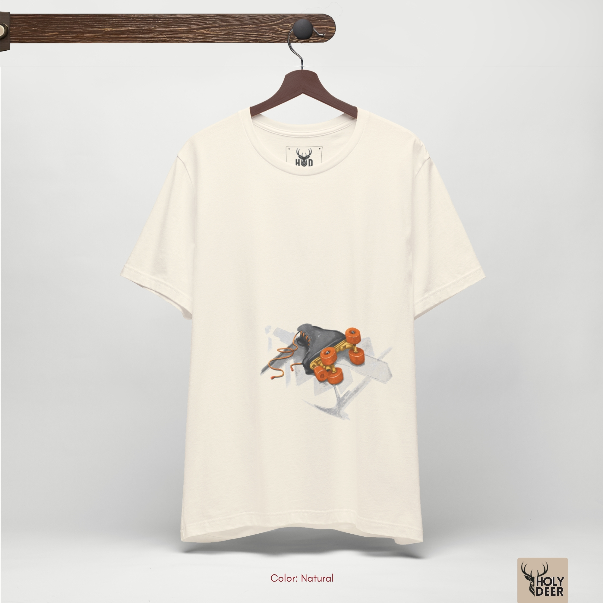 High-magnification print detail tracking the smooth orange ink coats, tiny central metallic bearing rings, and realistic lighting highlights forming the wheels of the quad skate shirt.
