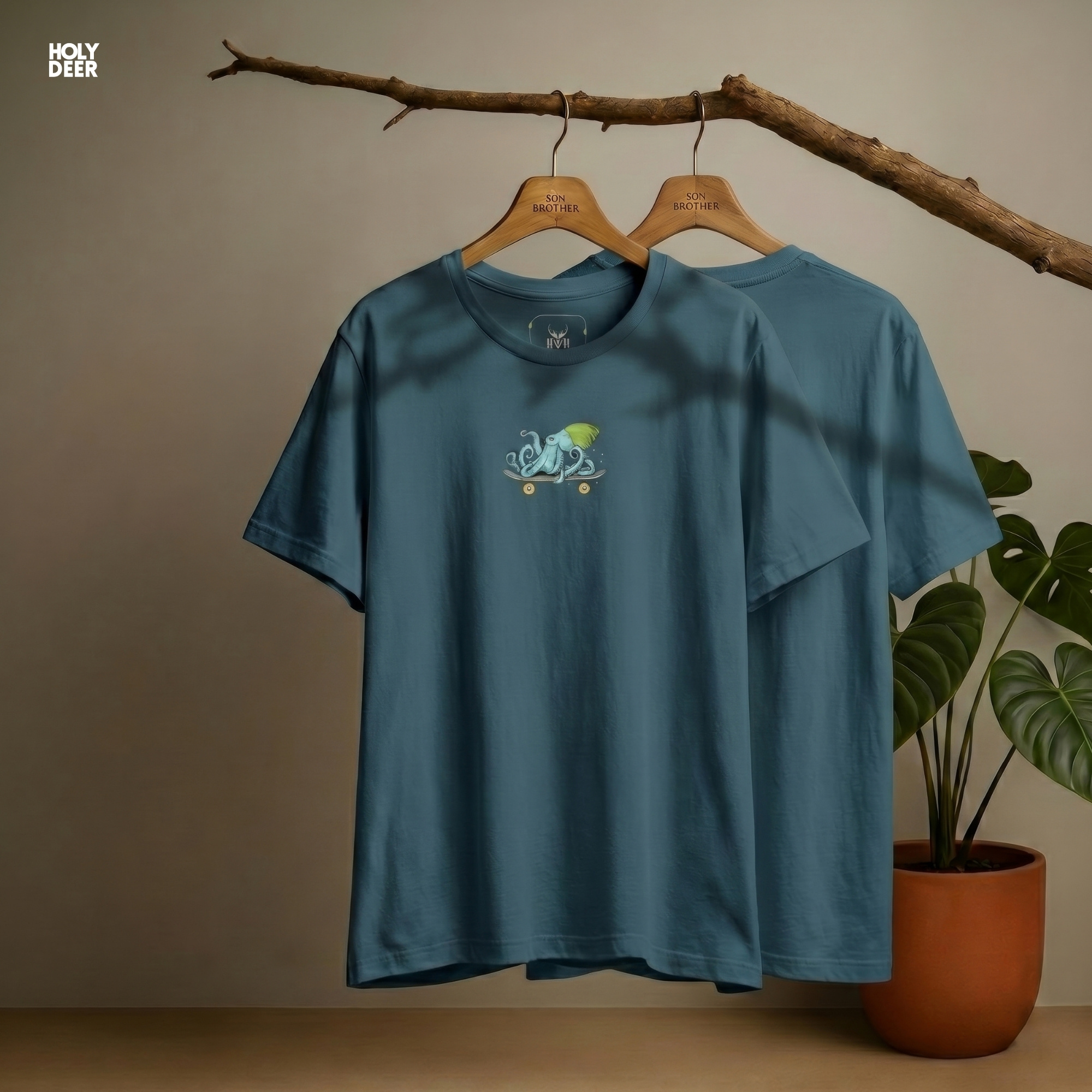 Professional flat lay photography of the Skater Octopus design by Holydeer Apparel, arranged elegantly next to premium urban illustration sketchbooks and high-end quirky streetwear accessories.