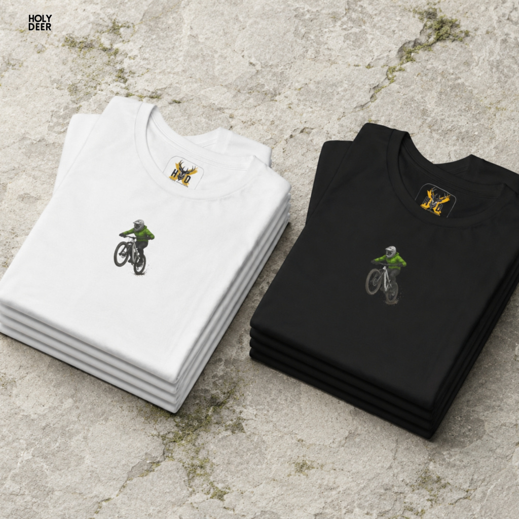 High-magnification print detail tracking the smooth green ink jacket coating, black sleeve creases, and helmet visor curves forming the body of the MTB graphic tee.