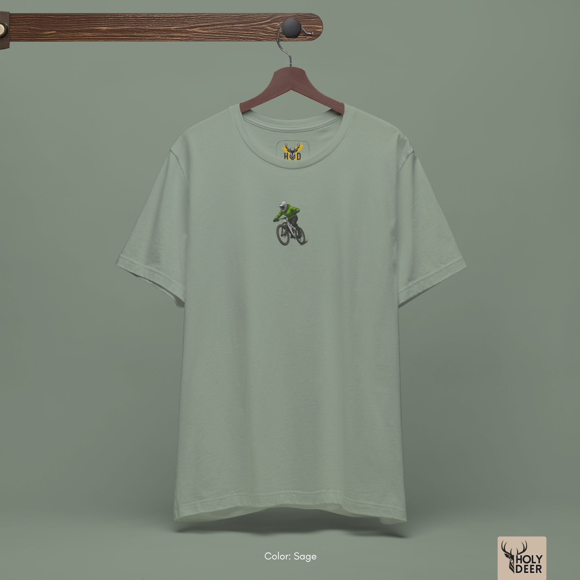 Overhead lookbook arrangement displaying the minimalist bike tee top folded neatly alongside emerald green gemstone specimens, dark chain links, and metallic repair multi-tools.