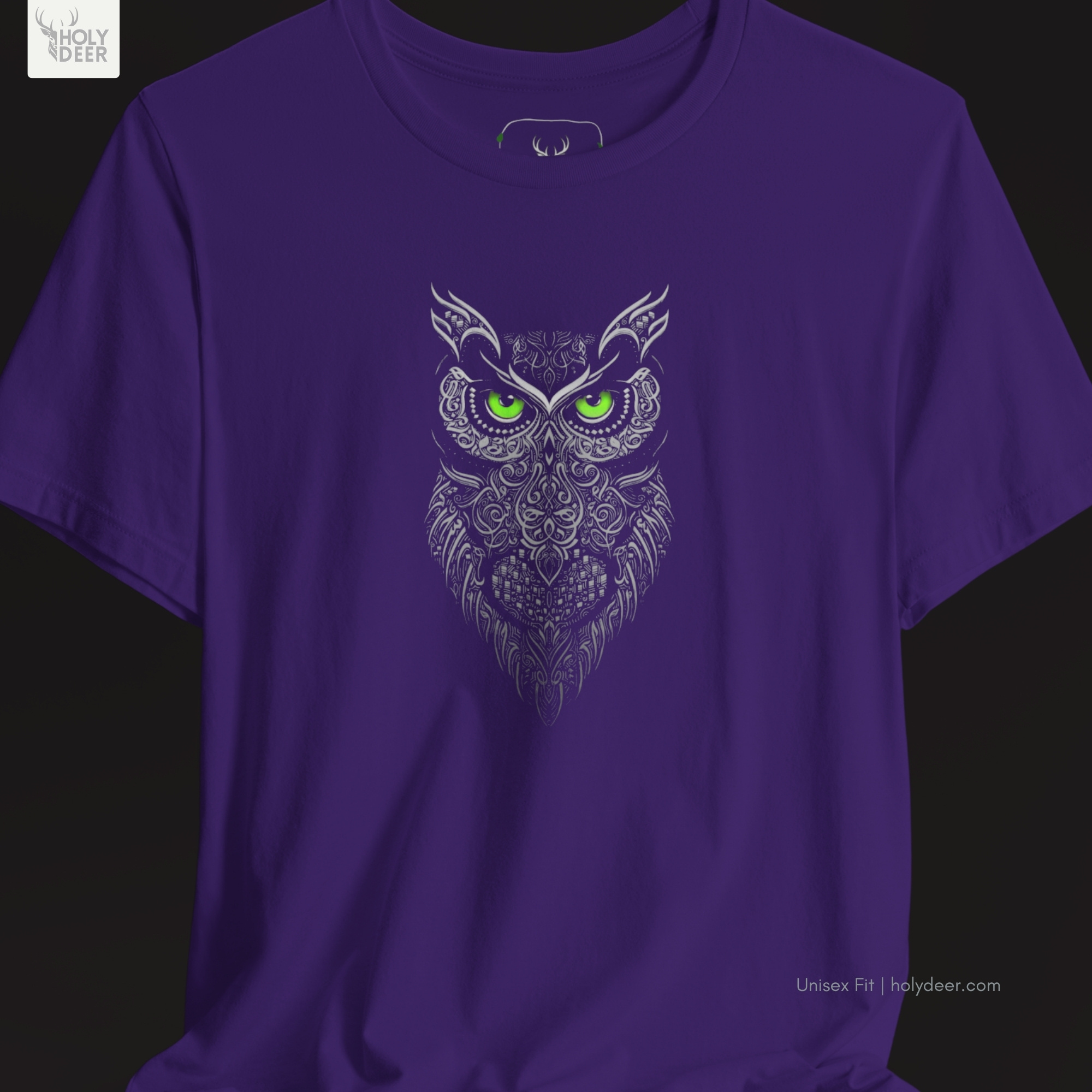 Overhead lookbook arrangement displaying the boho owl t-shirt folded neatly alongside green bands of gemstone minerals, custom compasses, and technical black blueprints.