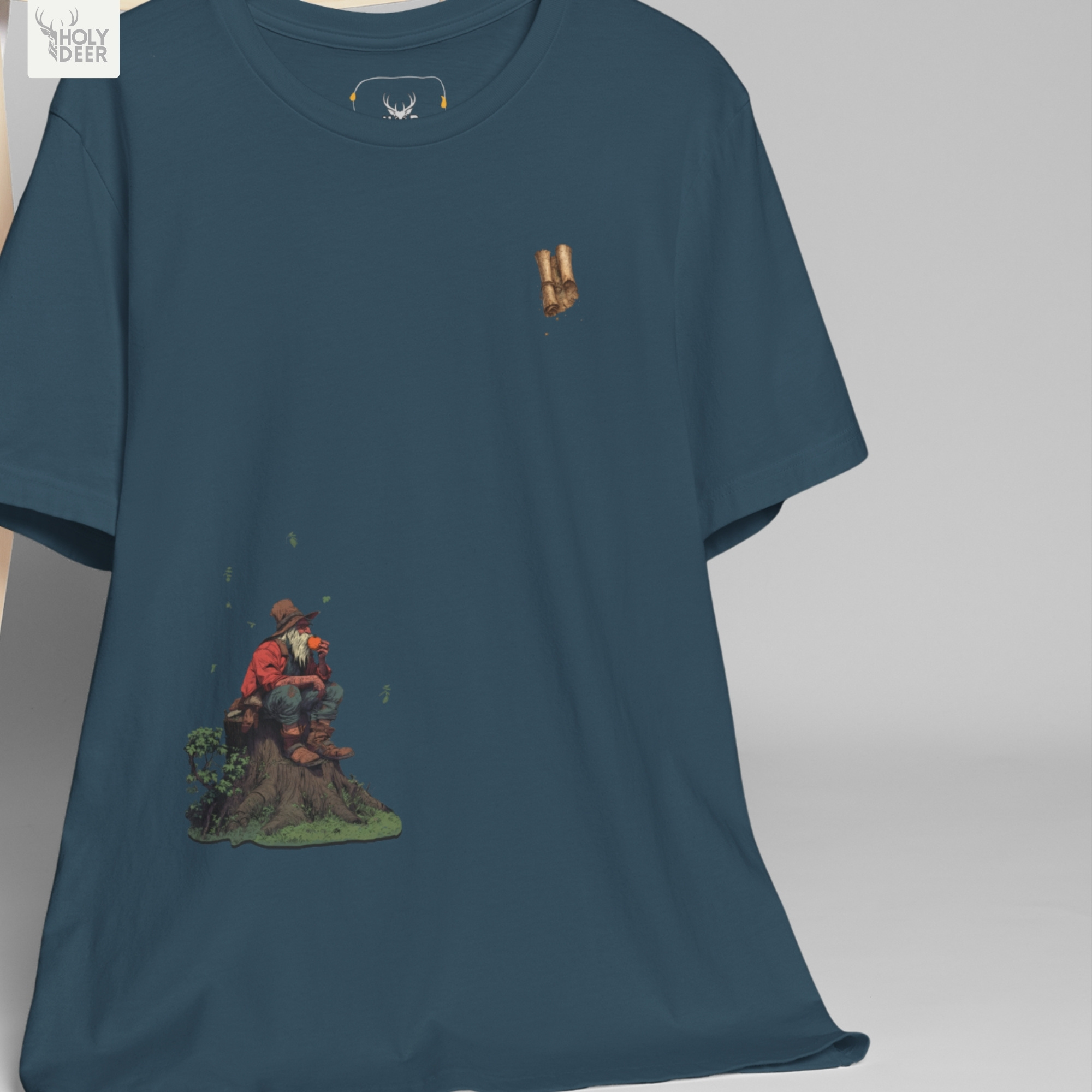 Professional flat lay photography of the Aesthetic Fantasy Storyteller Tee by Holydeer Apparel, arranged elegantly next to ancient leather-bound journals and high-end antique scholar collectibles.
