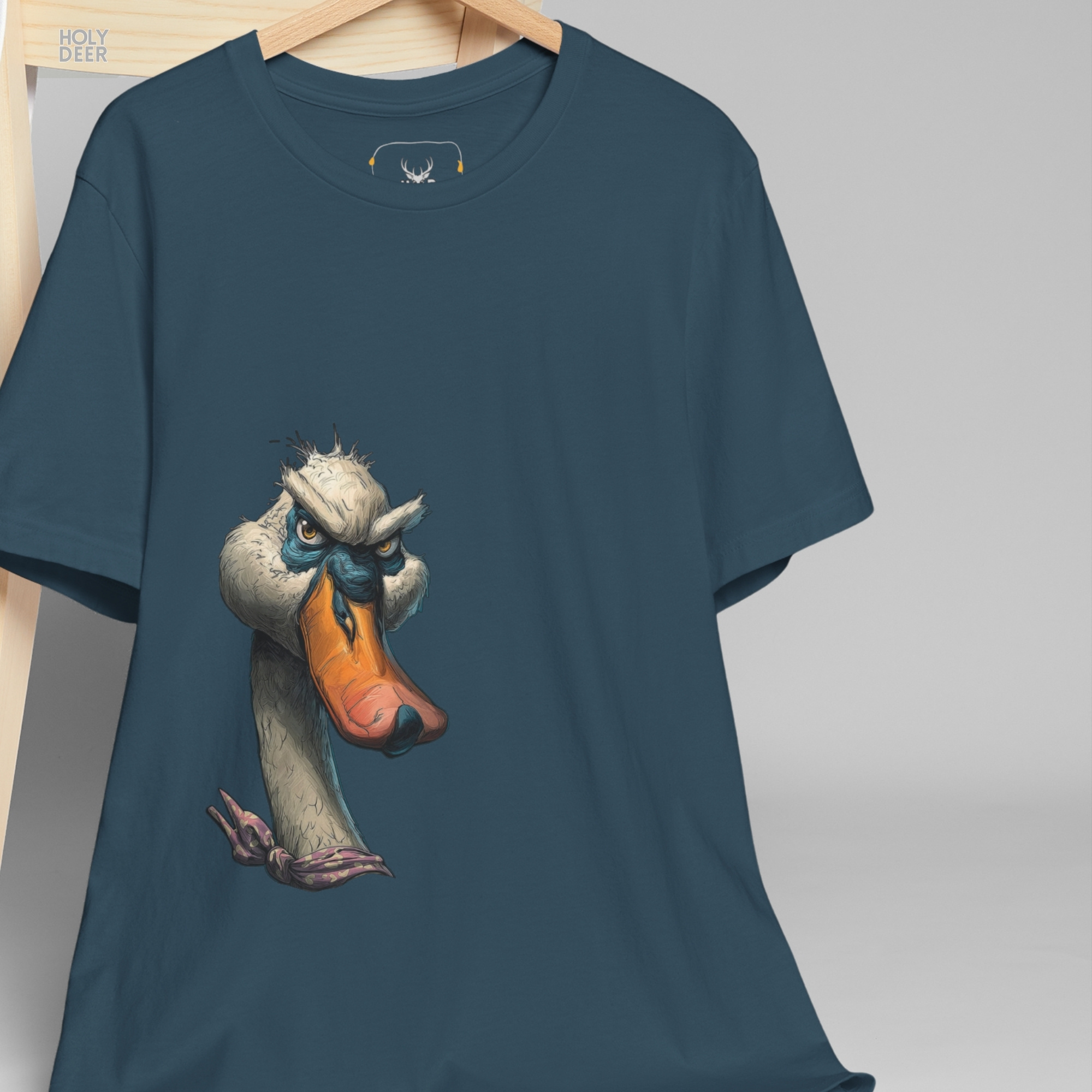 Professional flat lay photography of the Grumpy Duck Shirt by Holydeer Apparel, arranged elegantly next to premium creative artist wear sketches and high-end whimsical art piece accessories.