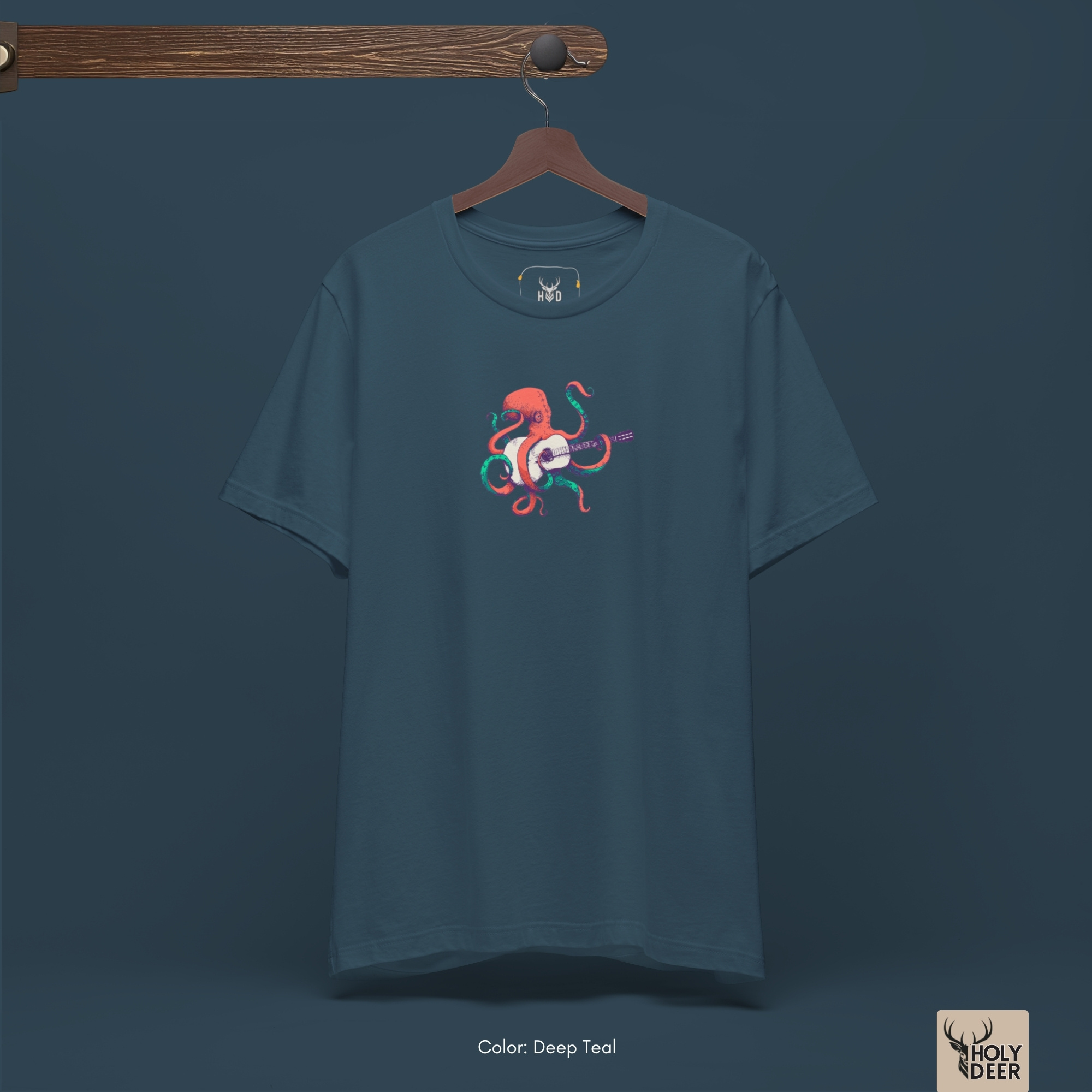 Macro view of the fine line-art details and clean contrast shading on the acoustic guitar headstock and tuning pegs embedded in the Indie Musician Tee artwork, showing the print depth that separates this holydeer tee from generic products.