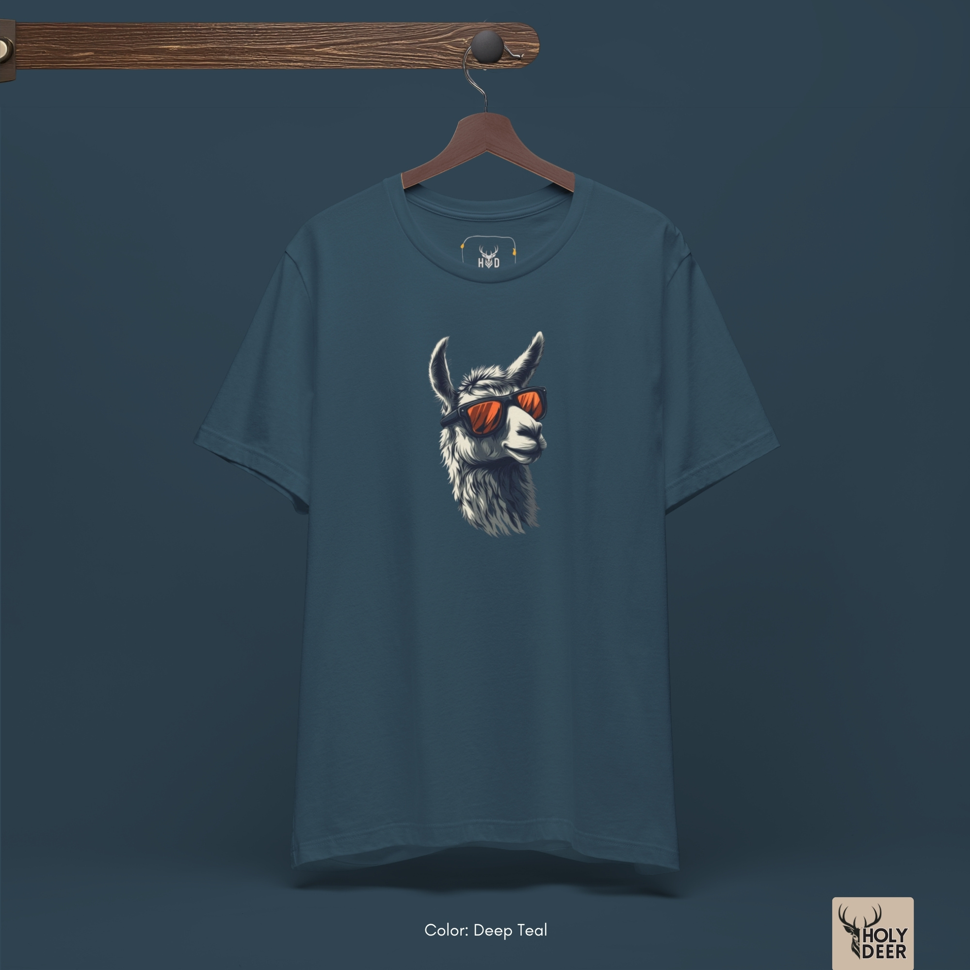 Dark shadow studio backdrop framing the unique Cool Llama Shirt by Holydeer Streetwear, magnifying the clean asymmetric placement and premium sunglasses llama tee presentation.