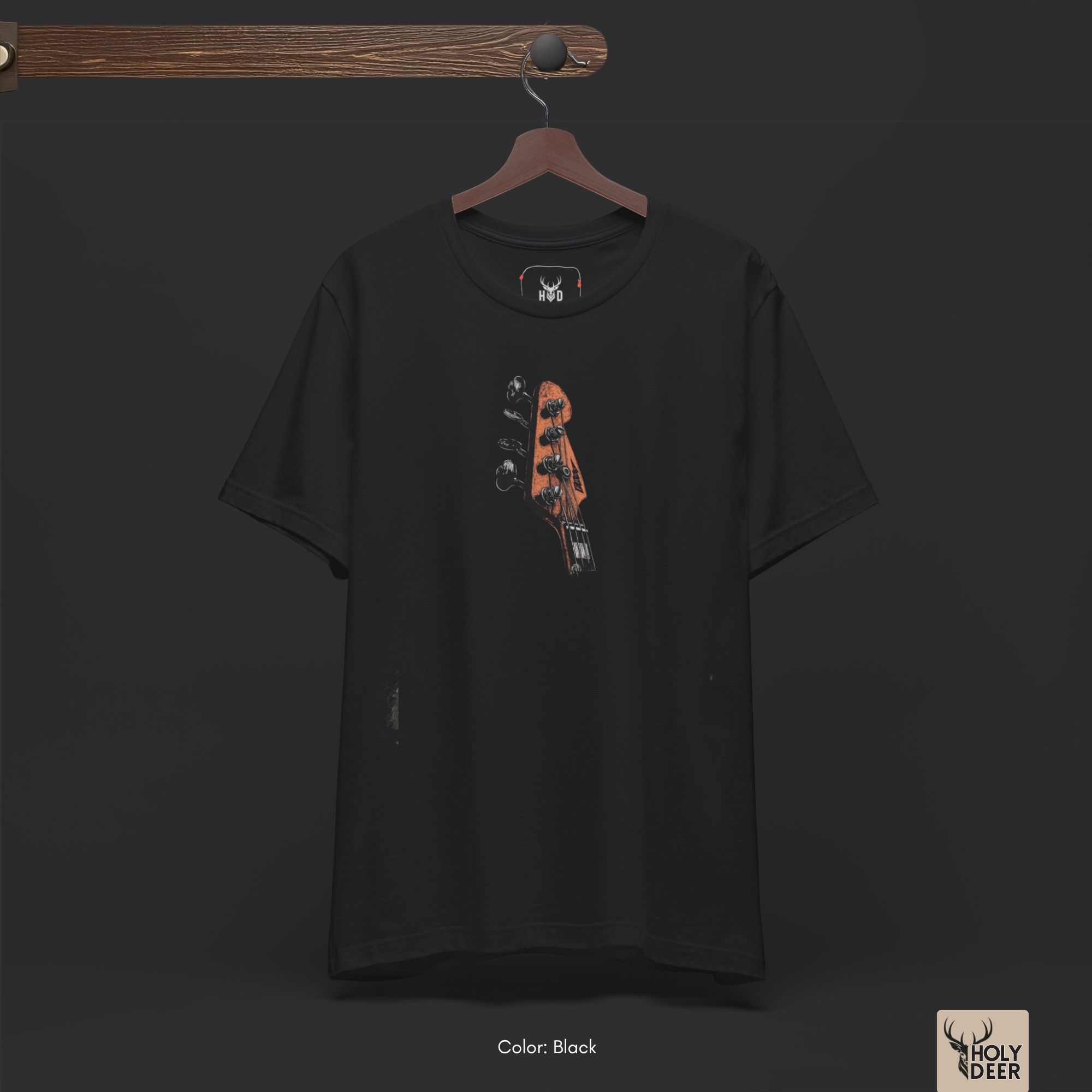 Warm atmospheric studio setup framing the unique Bass Guitar Tee by Holydeer Streetwear, spotlighting the clean minimalist bass headstock layout and top-tier indie creator wear presentation.