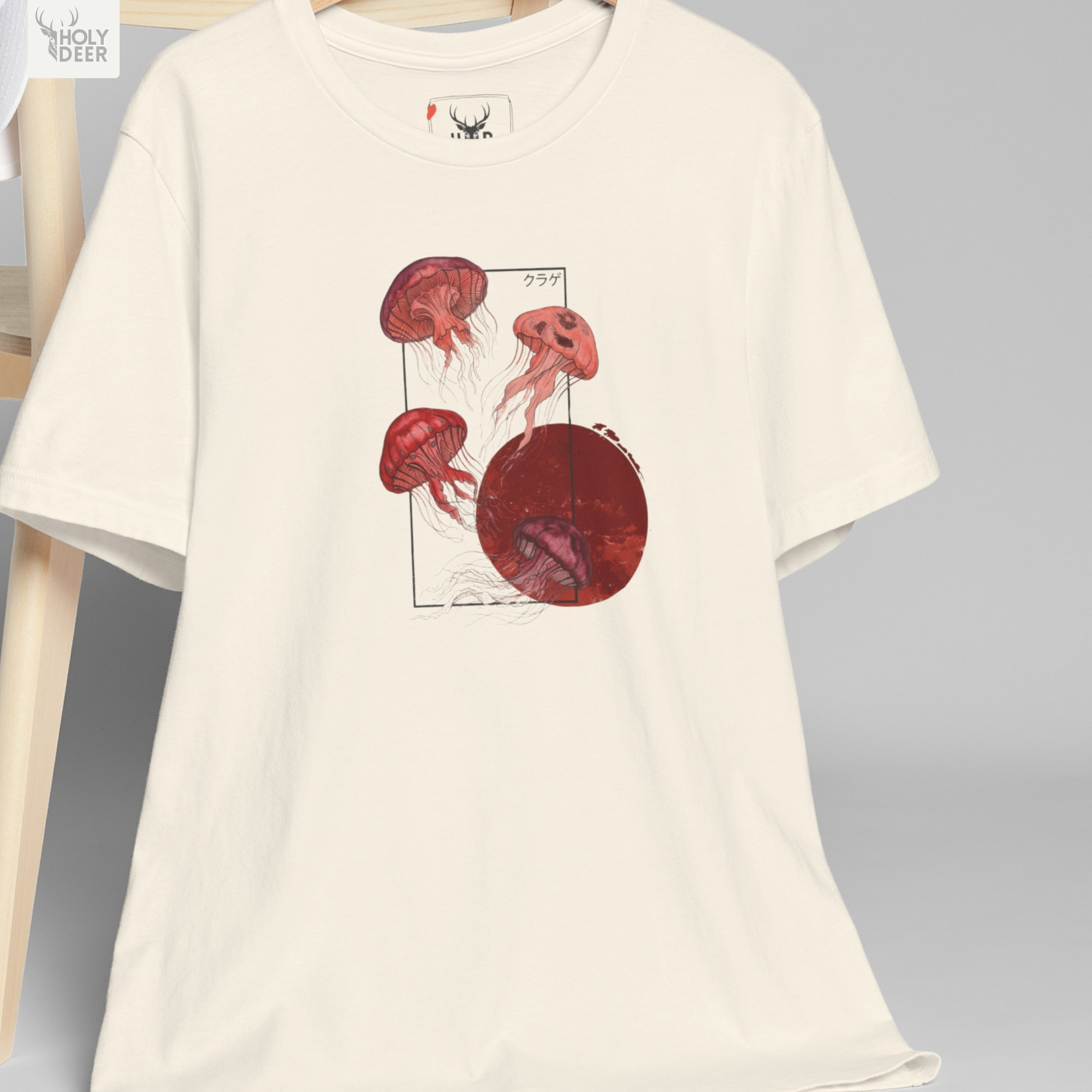 Professional flat lay photography of the Jellyfish T-Shirt by Holydeer Apparel, arranged cleanly next to vintage bamboo calligraphy brushes, traditional sumi ink blocks, and premium lifestyle aesthetic ocean top items.
