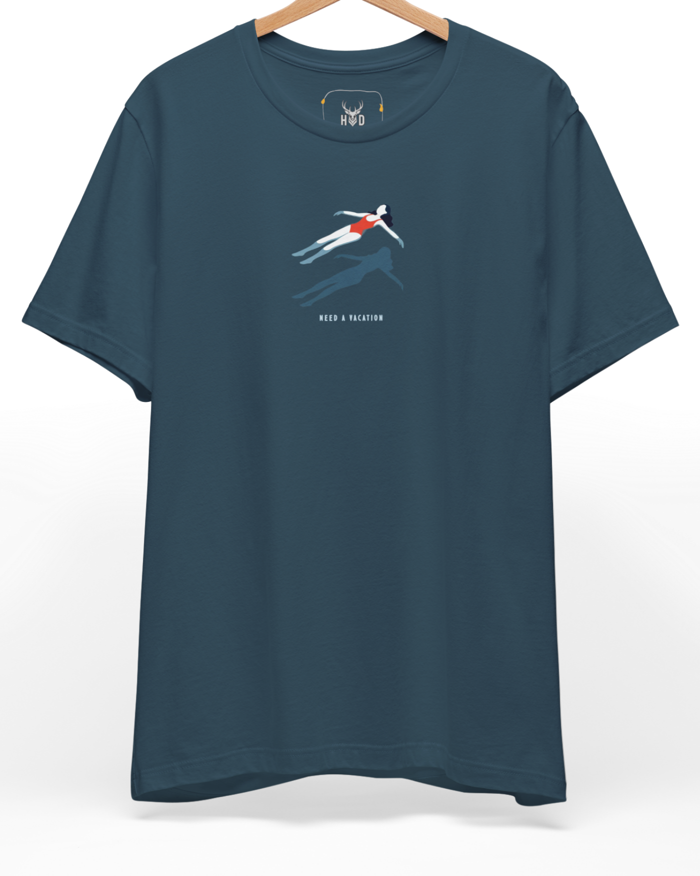 A high-end display of the official Holydeer Floating Girl Shirt showcasing unique Beach Life Apparel design lines. The central Need A Vacation Top graphic features a miniature Minimalist Swim Top layout centering a detailed surreal water shirt girl figure with a red swimsuit art posture casting a dark shadow printed squarely on a premium deep teal shirt canvas.