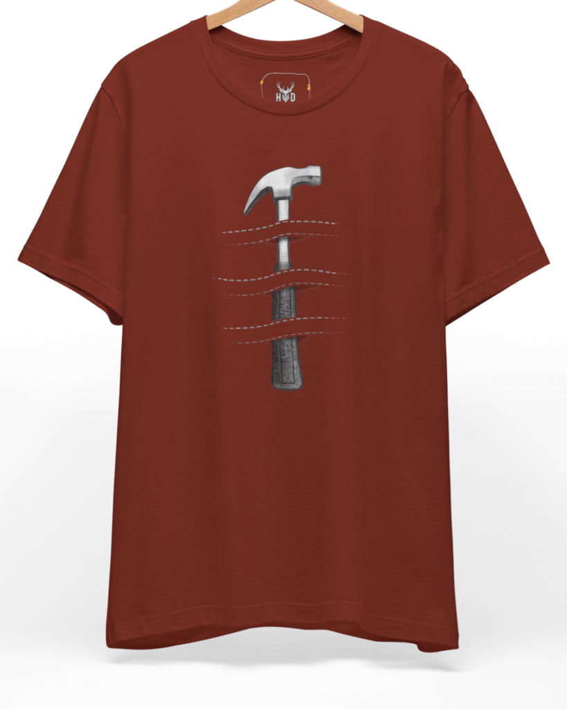 A high-end display of the official Holydeer Hammer Graphic Tee showcasing unique Industrial Apparel design lines. The central Craftsman Gift graphic features a miniature Creative Tools T layout centering a detailed Minimalist Hammer piece piercing an Optical Illusion T pattern with dashed stitch cuts printed squarely on a rust shirt canvas.