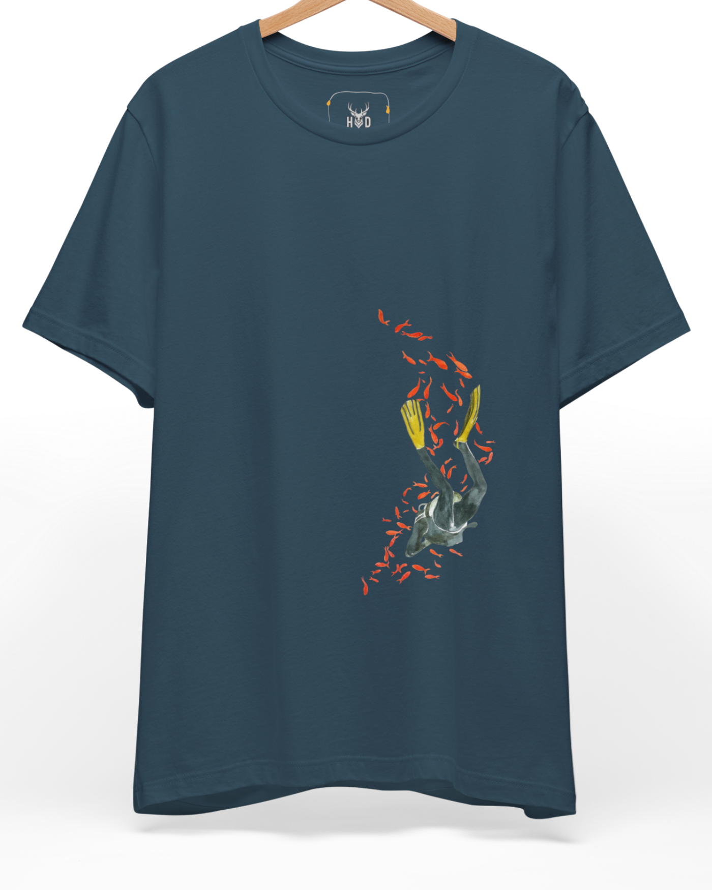 A high-end display of the official Holydeer Scuba Diving Shirt showcasing unique Nautical Streetwear design lines. The central Ocean Adventure Top graphic features a miniature Freediving Apparel layout centering a detailed Undersea Explorer T diver surrounded by a swirling orange School of Fish Tee pattern printed squarely on a deep teal shirt canvas.