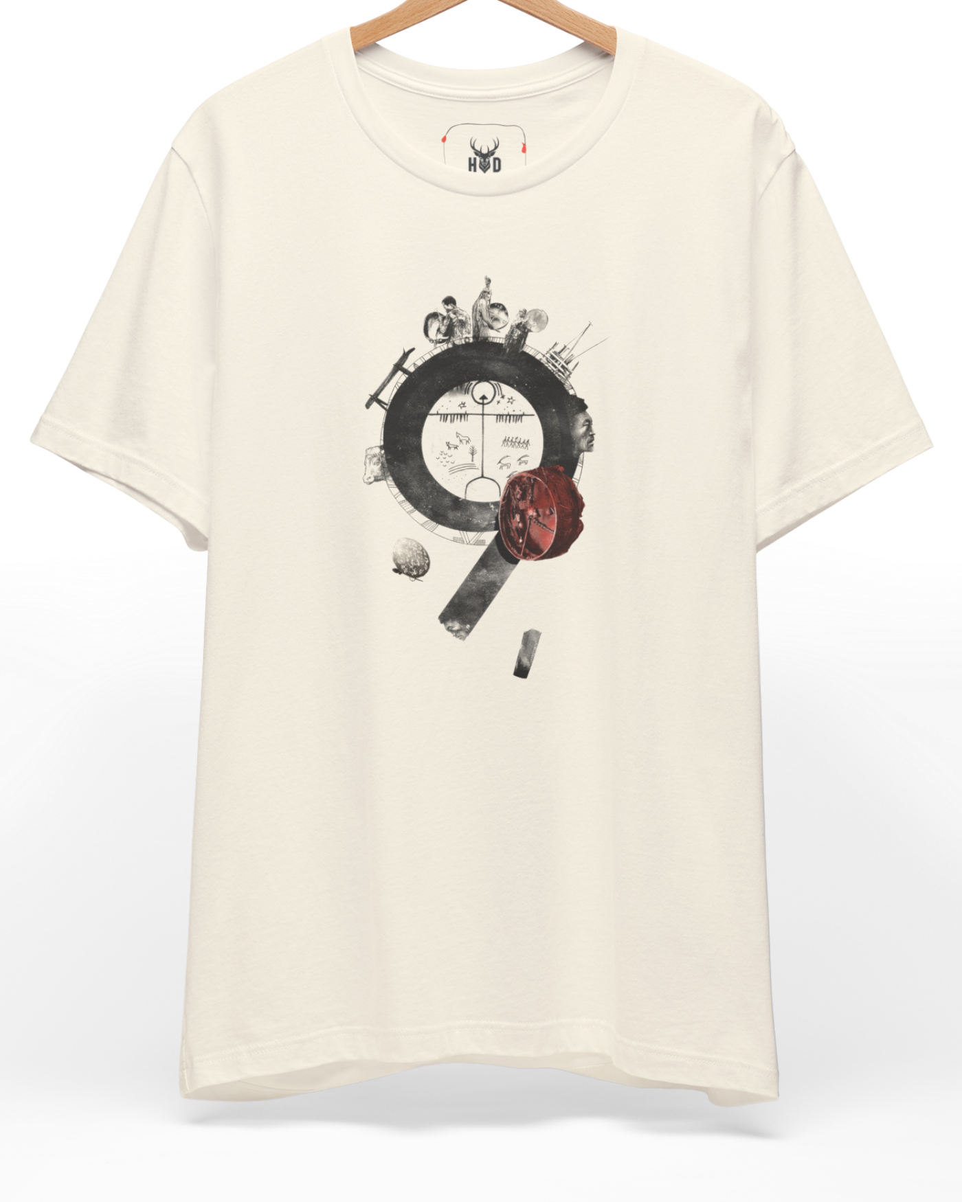 A high-end display of the official Holydeer Shamanic Shaman Tee showcasing unique Nomad Culture Wear design lines. The central Tengri Symbol Shirt graphic features a miniature Ethnic Graphic Tee layout centering a detailed Archaic Petroglyph ring, historical figures, and a deep red Mystic Shaman Drum printed squarely on a natural cotton shirt canvas.