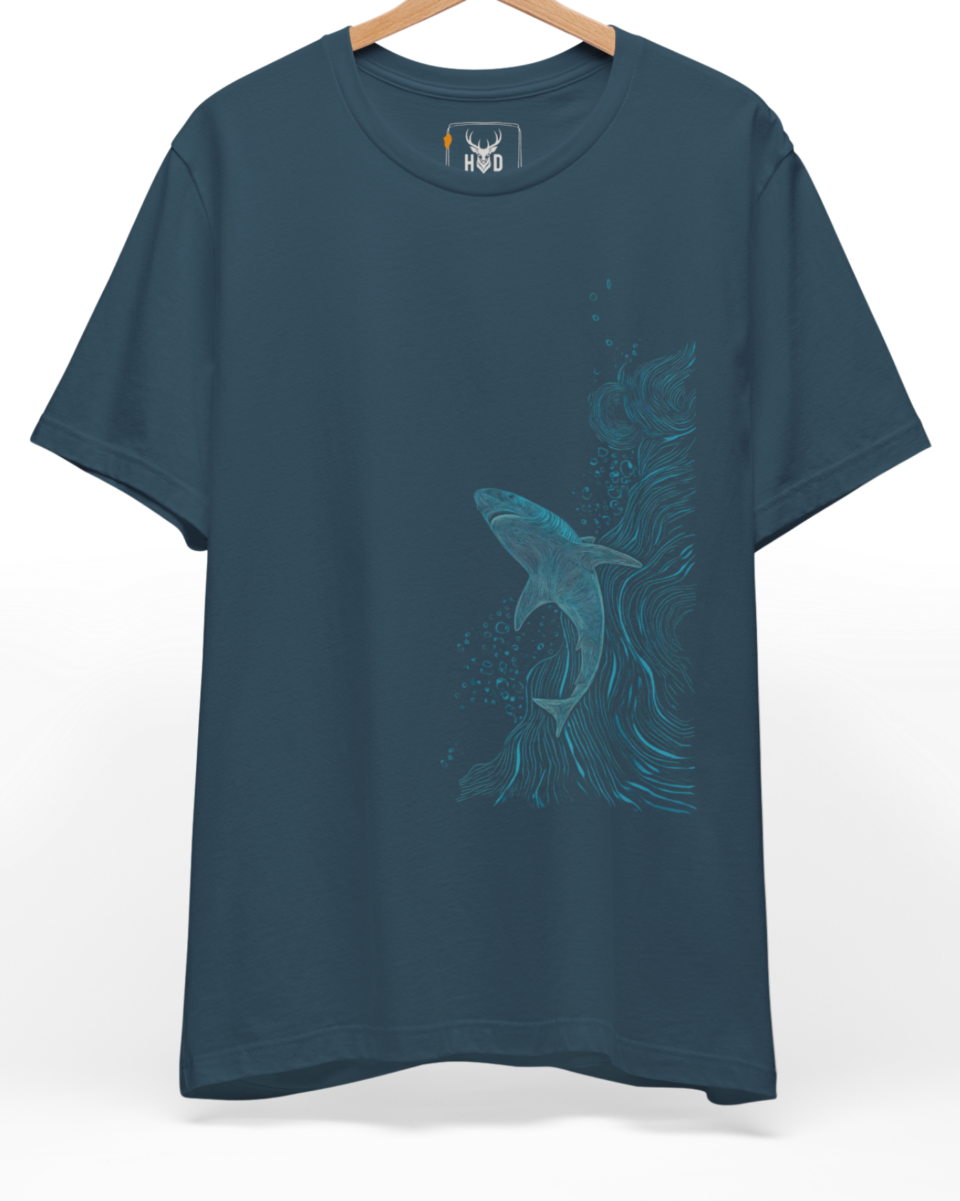 A high-end display of the official Holydeer Shark Graphic Tee showcasing unique Nautical Streetwear design lines. The central Ocean Adventure Top graphic features a miniature Oceanic Line Art layout centering a detailed Apex Predator Shirt shark silhouette woven from thin blue overlapping waves printed squarely on a deep teal shirt canvas.