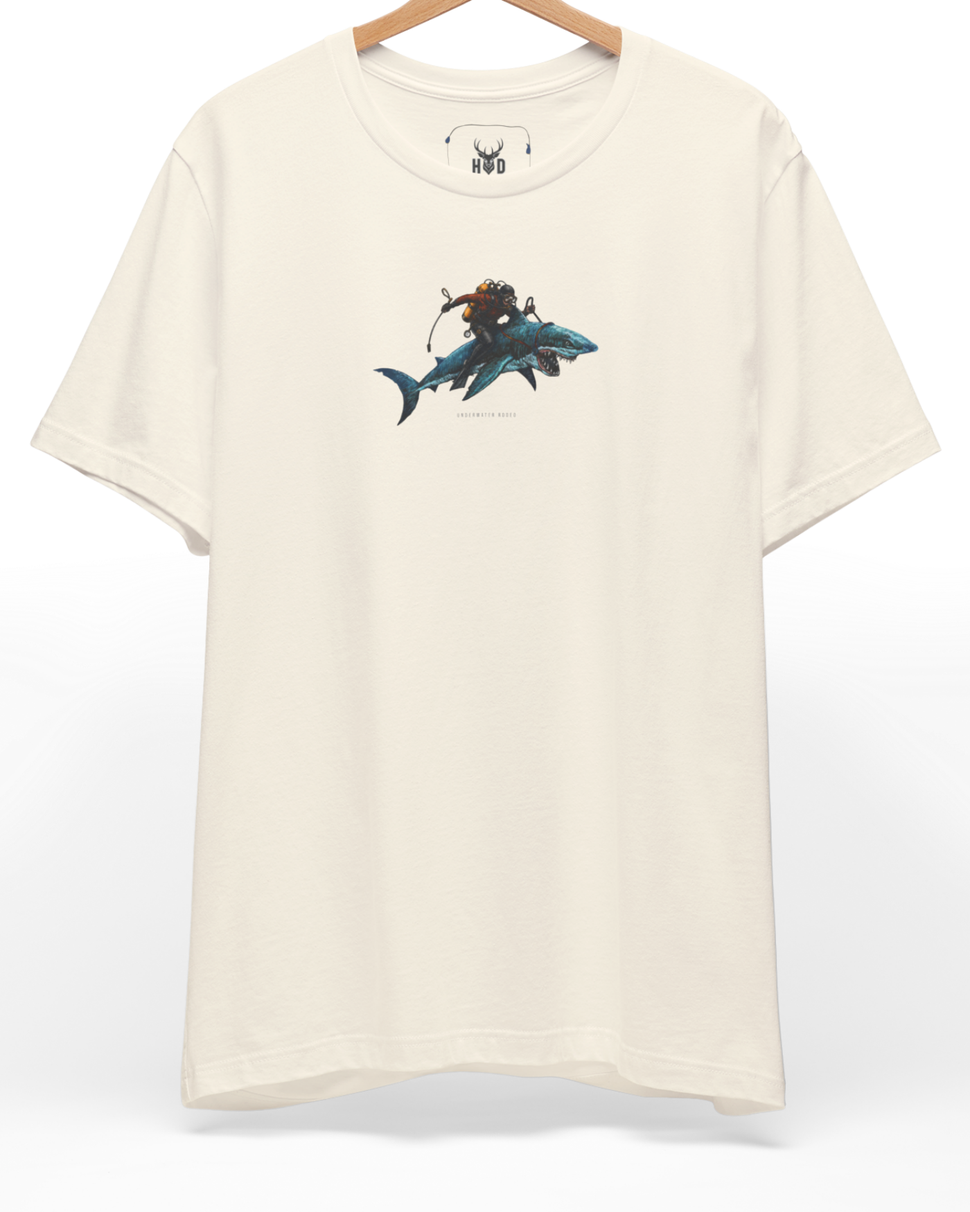 A high-end display of the official Holydeer Shark Graphic Tee showcasing unique Nautical Streetwear design lines. The central Underwater Rodeo graphic features a miniature Surreal Shark Art layout centering a detailed Diver Gift Shirt shark with a custom yellow-tank scuba diver gift riding on its back printed squarely on a natural canvas.